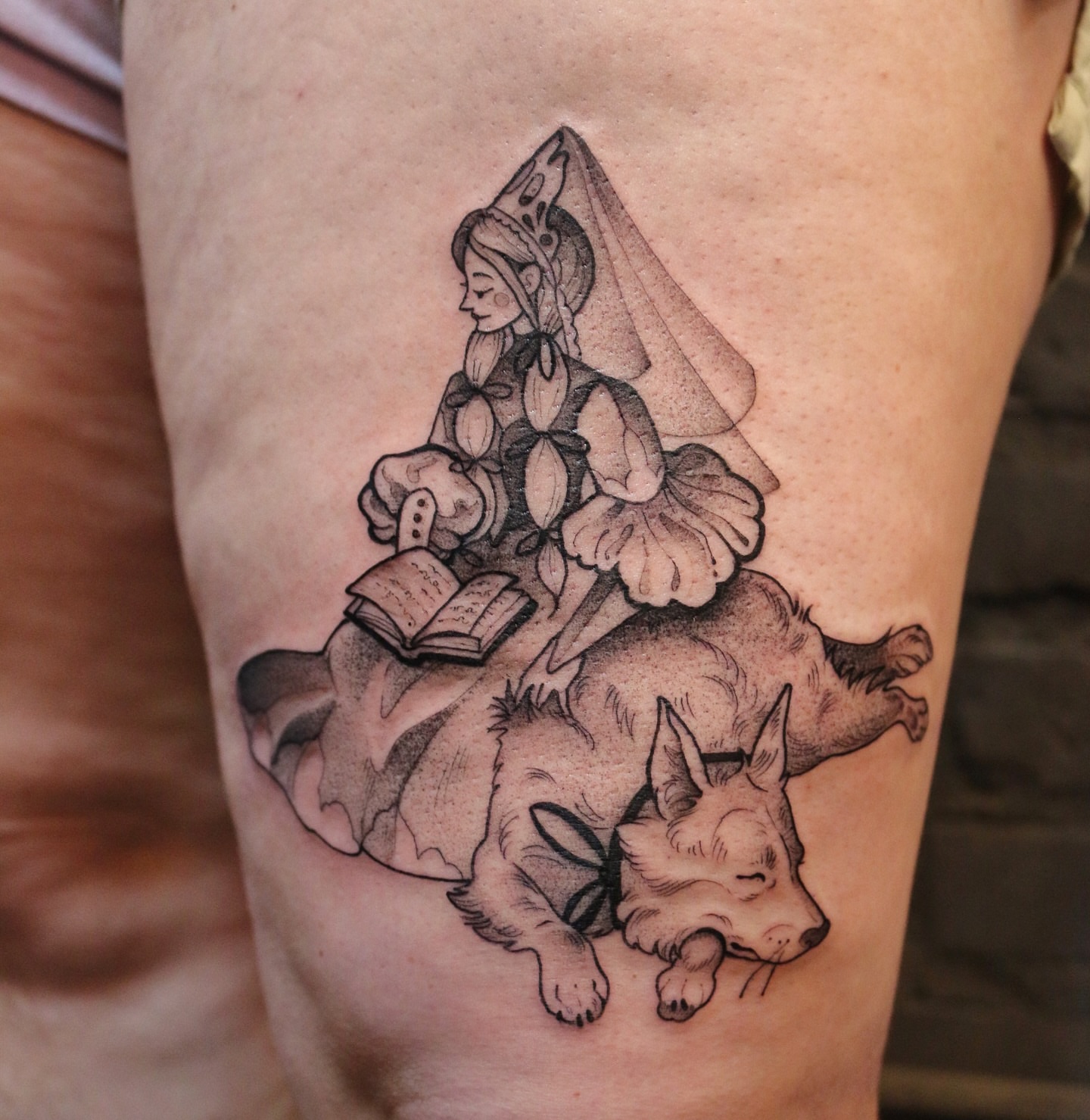 Woman reading with dog realism tattoo on the thigh by Summer Balcom M.