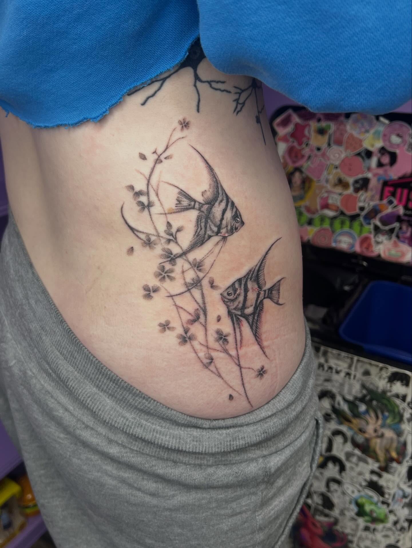Angelfish and blossoms realism tattoo on the ribs by Ebony Robinson, Austintown, Ohio