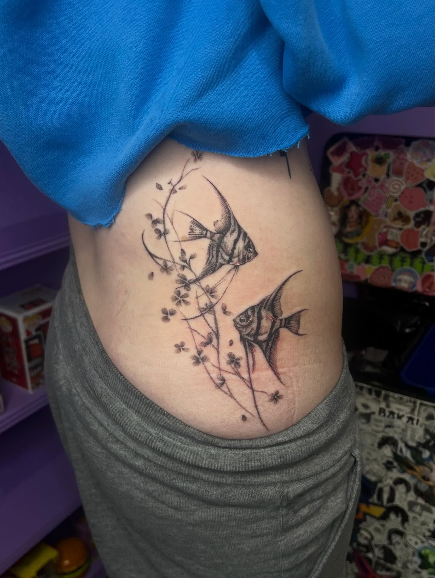 Angelfish and flowers black and grey tattoo on the thigh by Ebony Robinson, Austintown, Ohio