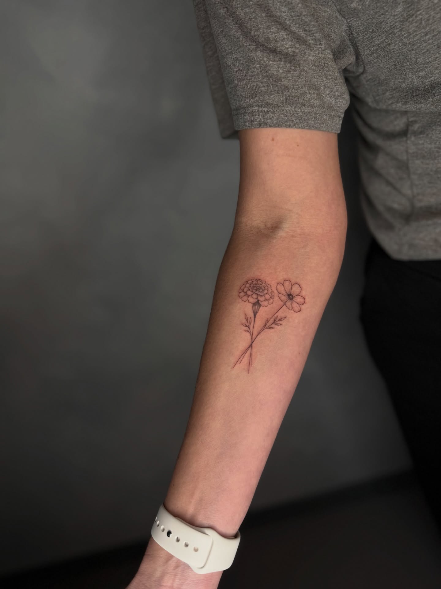 Flowers fine line tattoo on the forearm by Fineline Tattoos DFW
