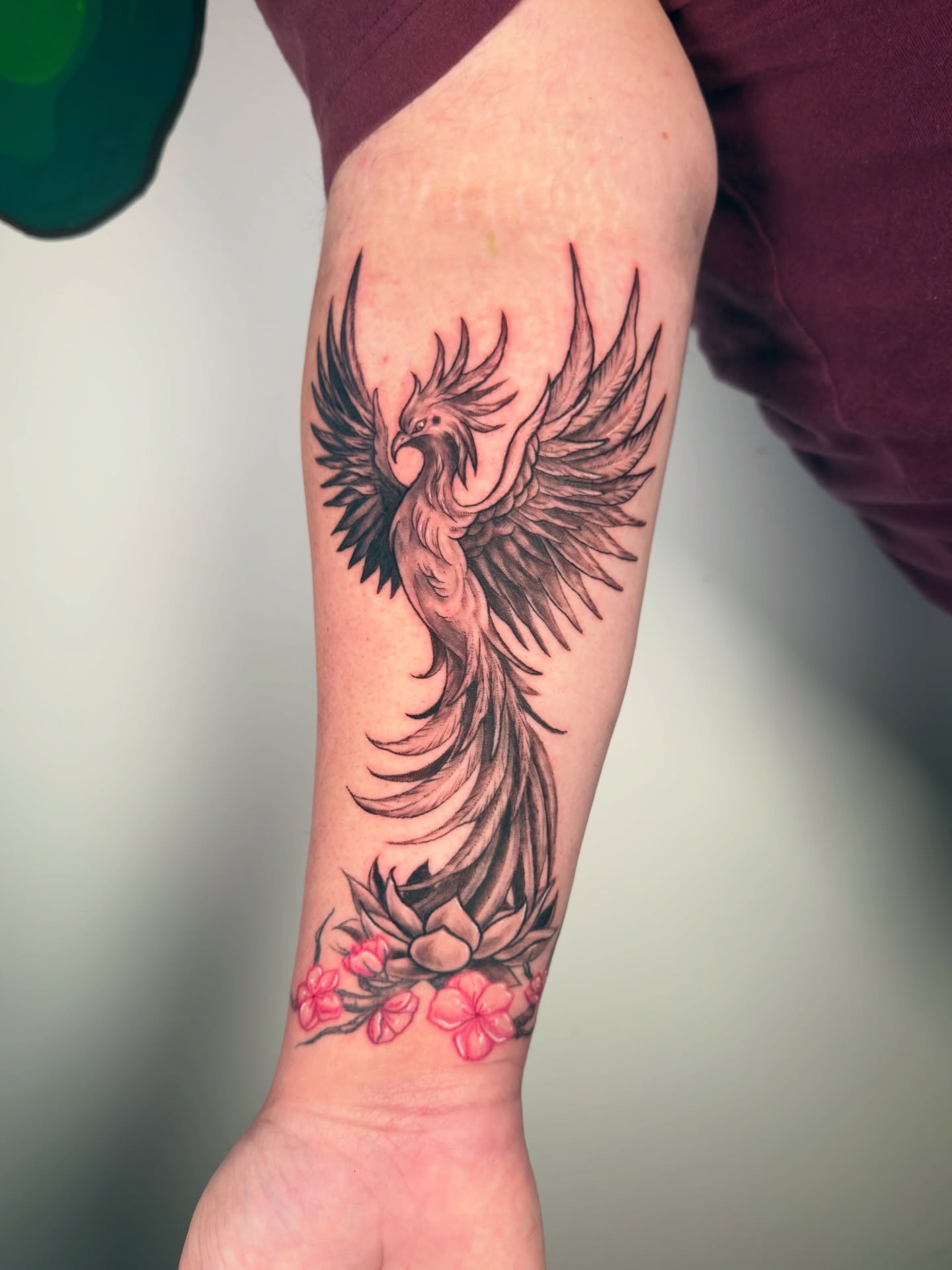 Phoenix black and grey tattoo on the forearm by Diana