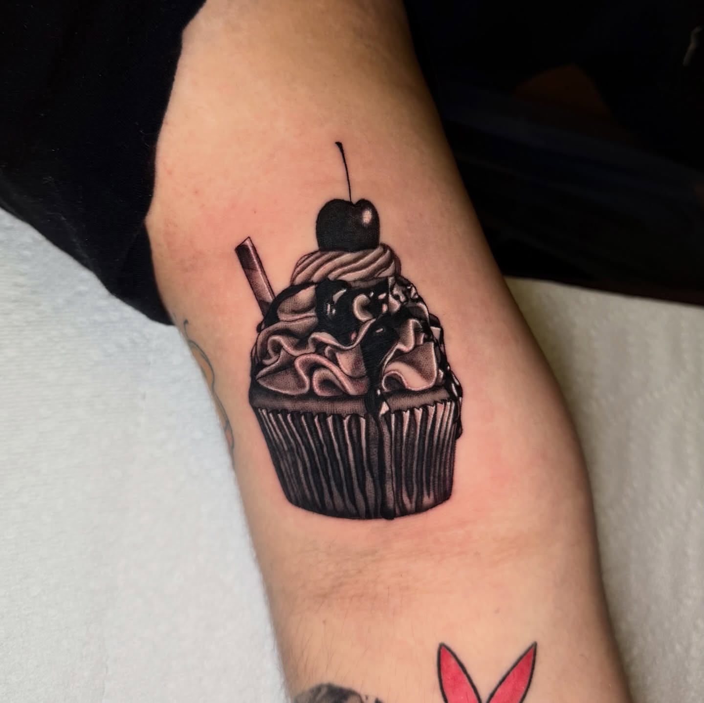Cupcake black and grey tattoo on the forearm by 𝖎𝖘𝖆 ✶ 𝖉𝖋𝖜 𝖙𝖆𝖙𝖙𝖔𝖔𝖘