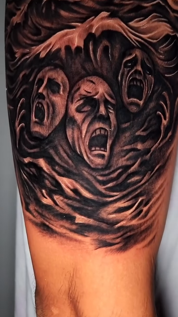 Screaming faces in a storm dark realism tattoo by professional tattoo artist