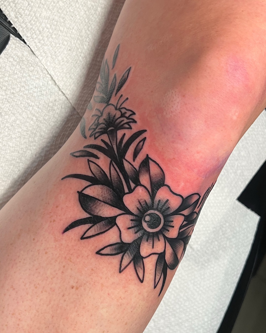 Flower bouquet black and grey tattoo on the forearm by @shannonkeeleyy