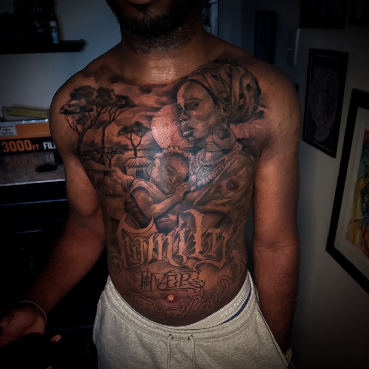 Family realism tattoo on the chest by Jared McGee