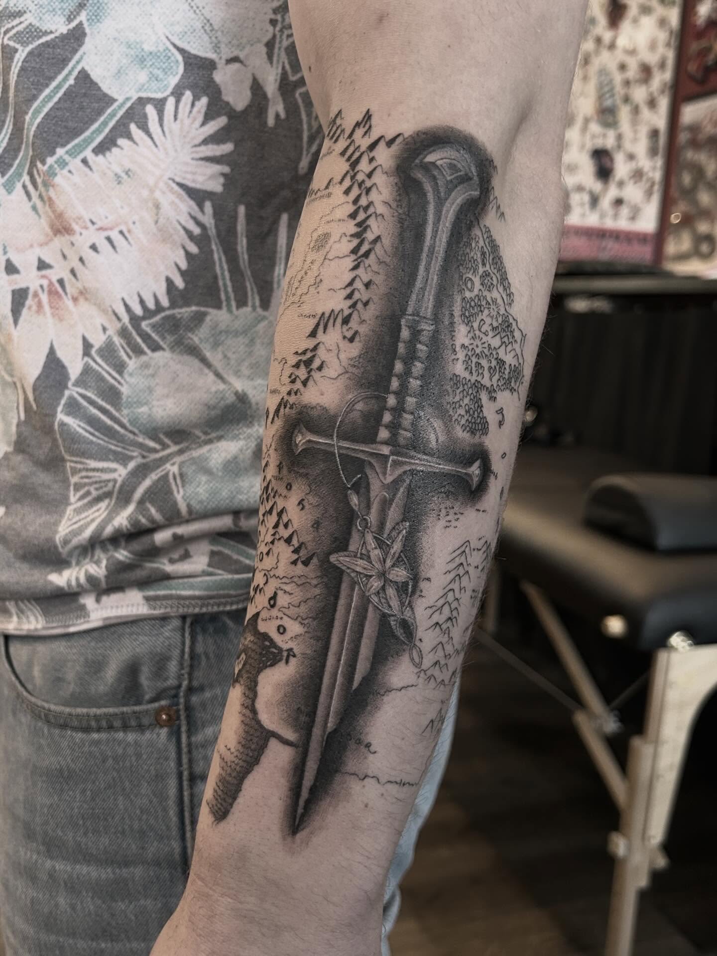 Sword and cross realism tattoo on the forearm by Tako, Seattle, Washington