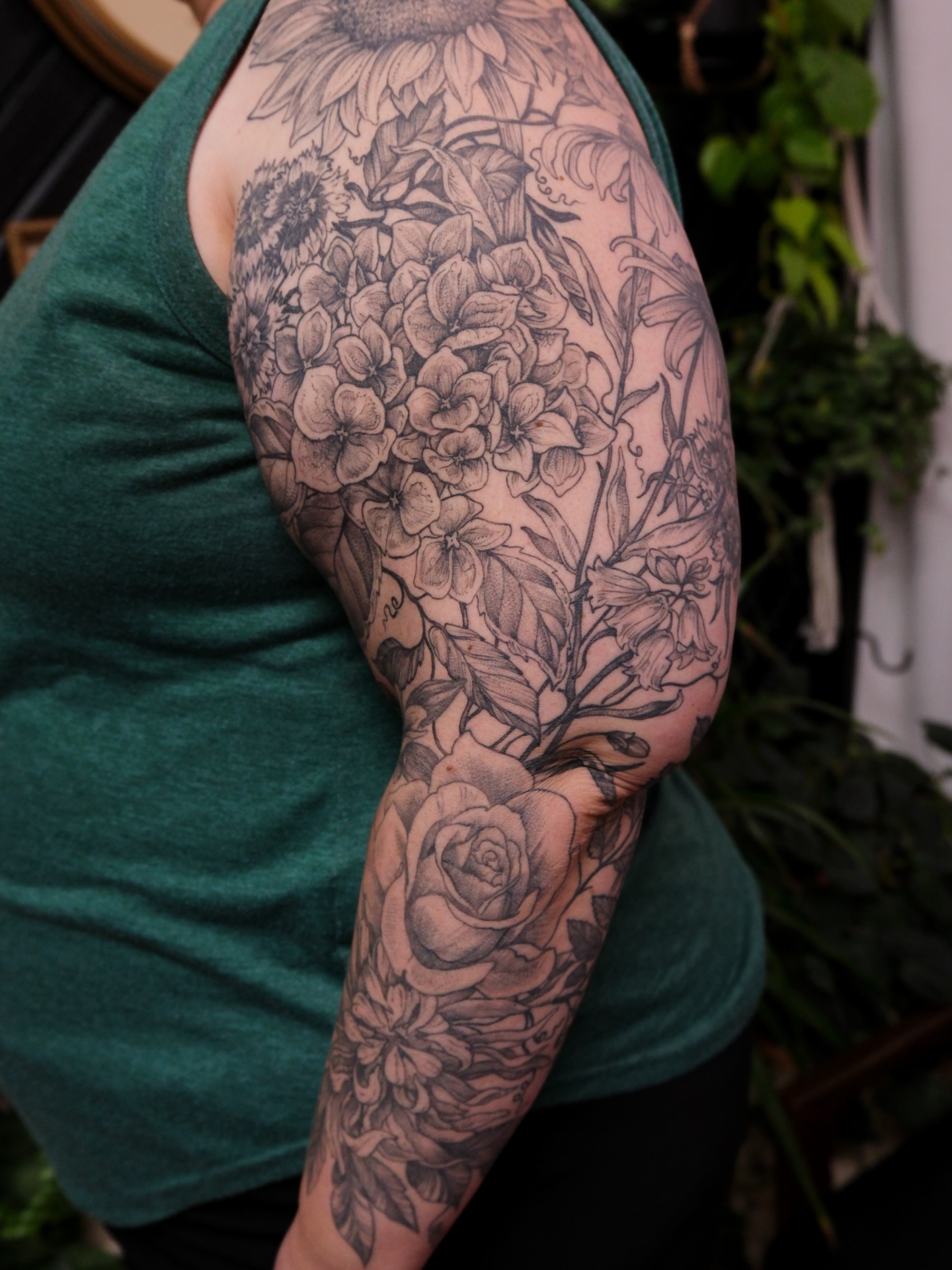 Floral bouquet black and grey tattoo on the upper arm by Renee (Koi) Vance