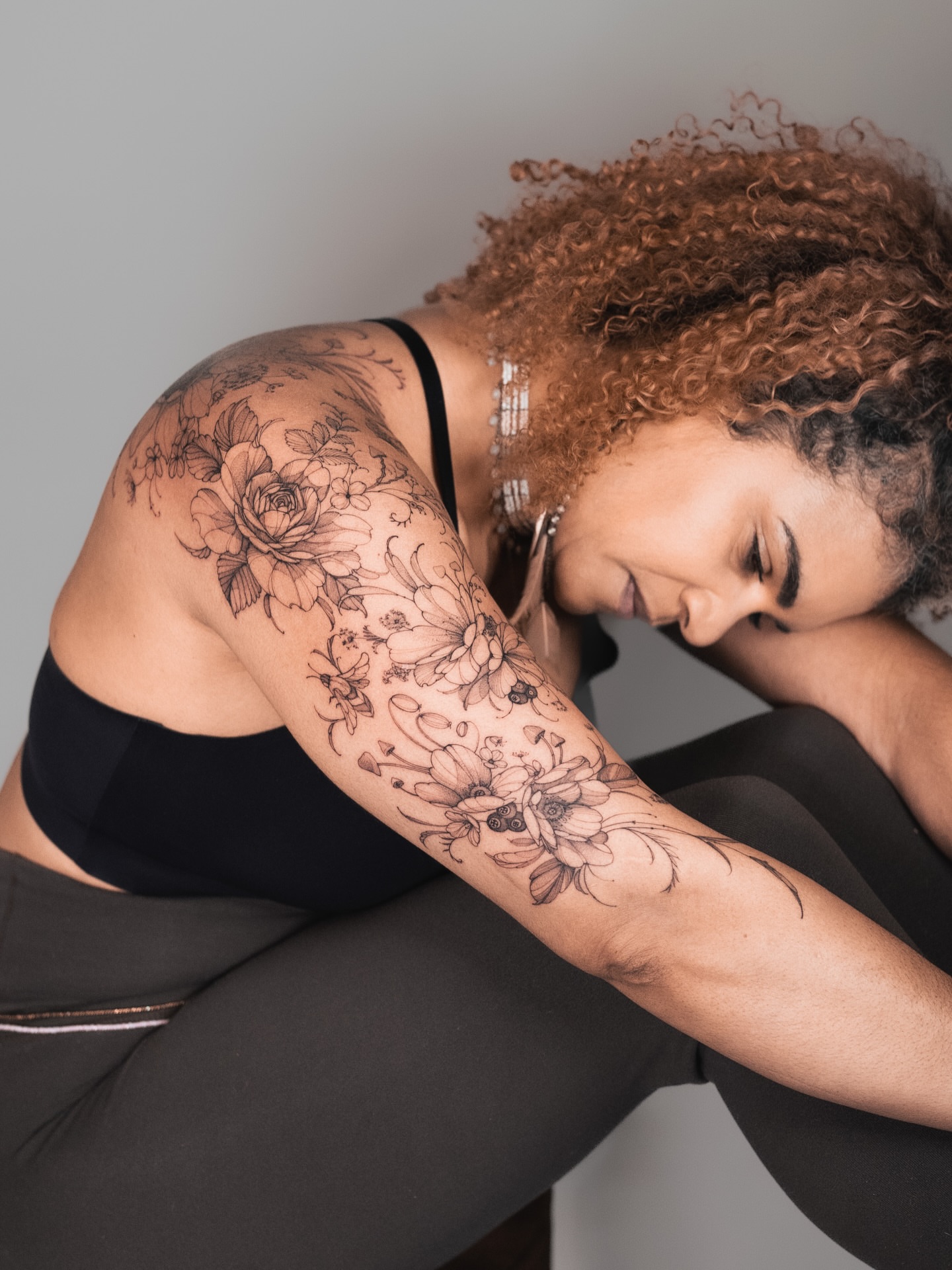 Floral bouquet black and grey tattoo on the upper arm by Yuliia Babych tattoo AUSTIN