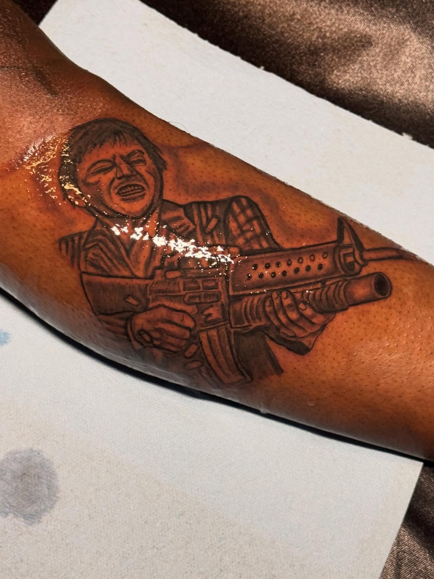 Gun-wielding character realism tattoo on the forearm by dallas tattoo artist, Duncanville, Texas