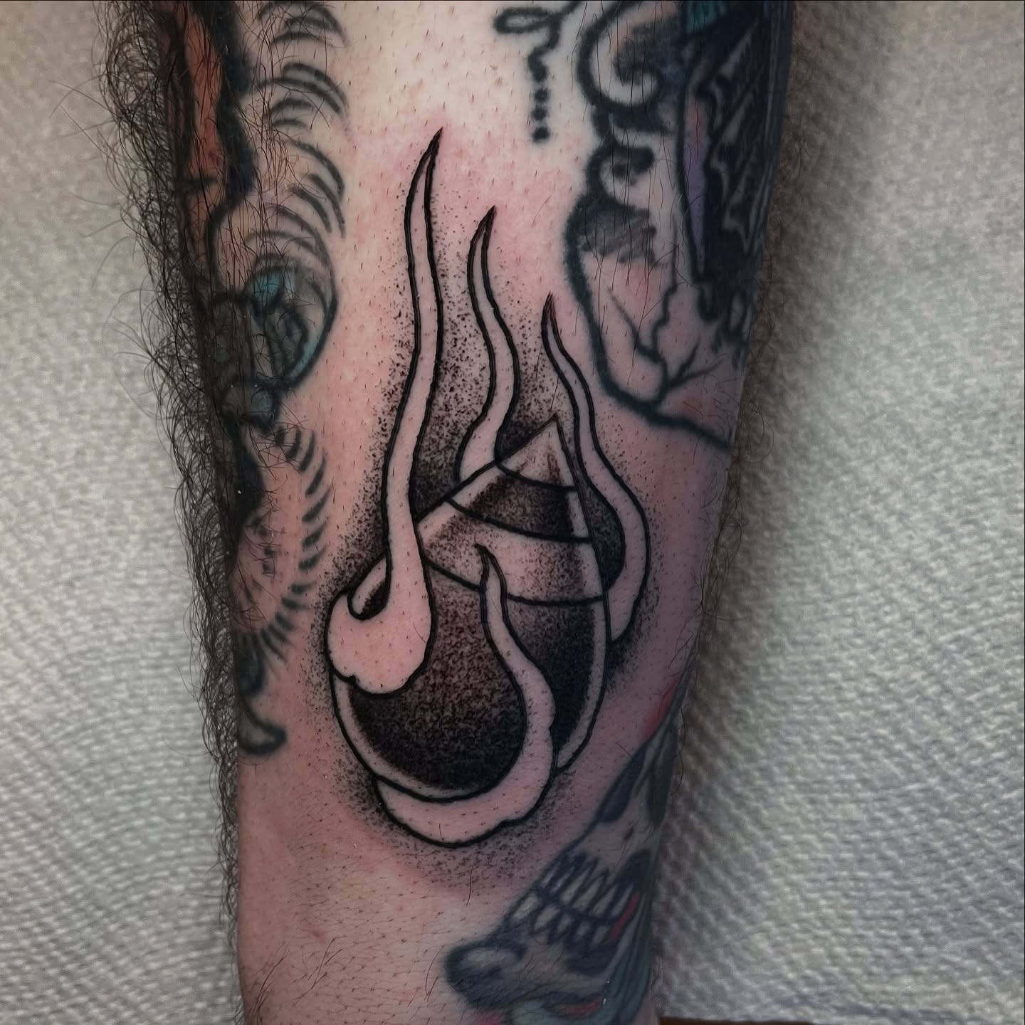 Flame dotwork tattoo on the forearm by Ian Spong