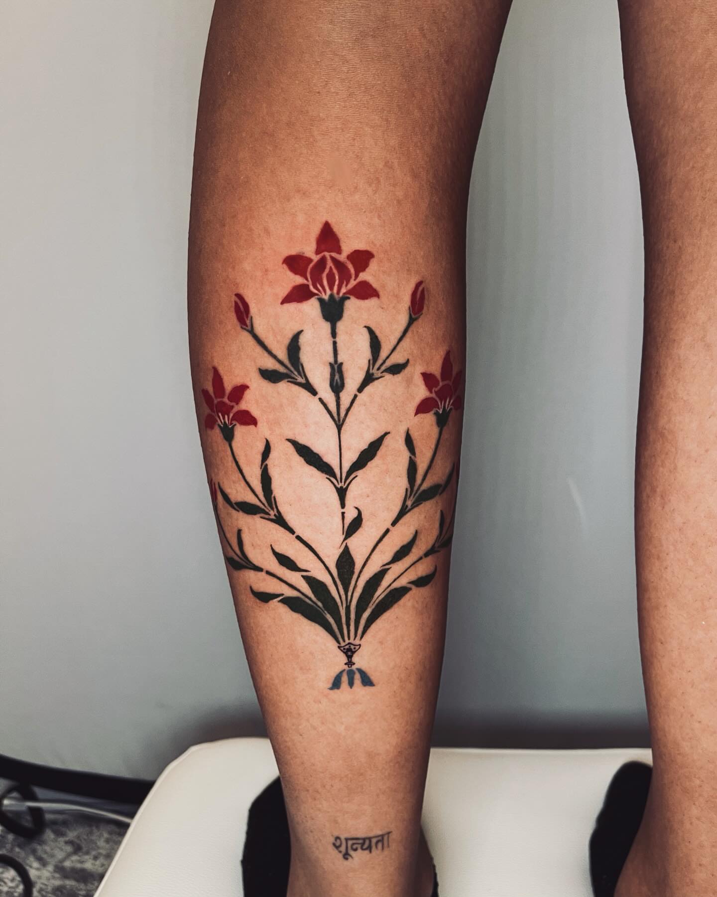 Floral bouquet black and grey tattoo on the forearm by vivian