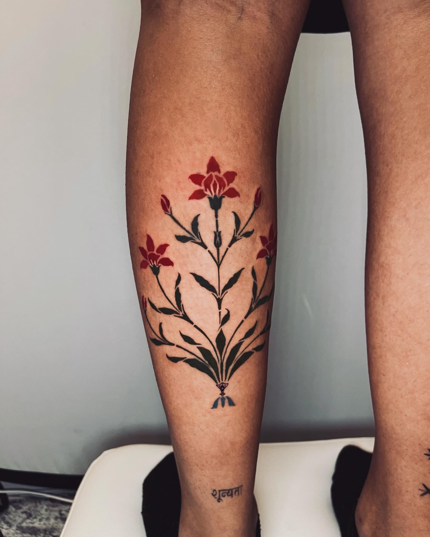 Floral bouquet black and grey tattoo on the calf by vivian