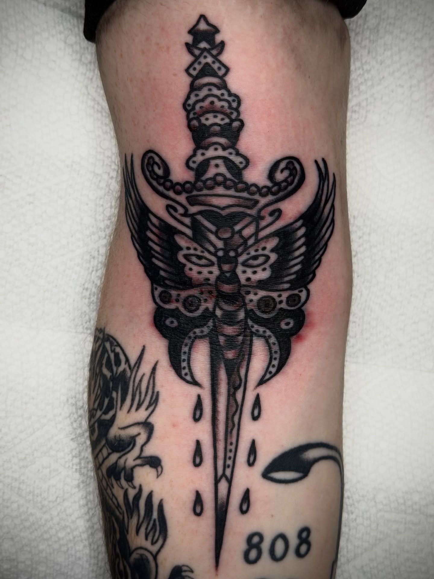 Sword with wings American traditional tattoo on the forearm by Kyle O’Hara ॐ, Nashville, Tennessee