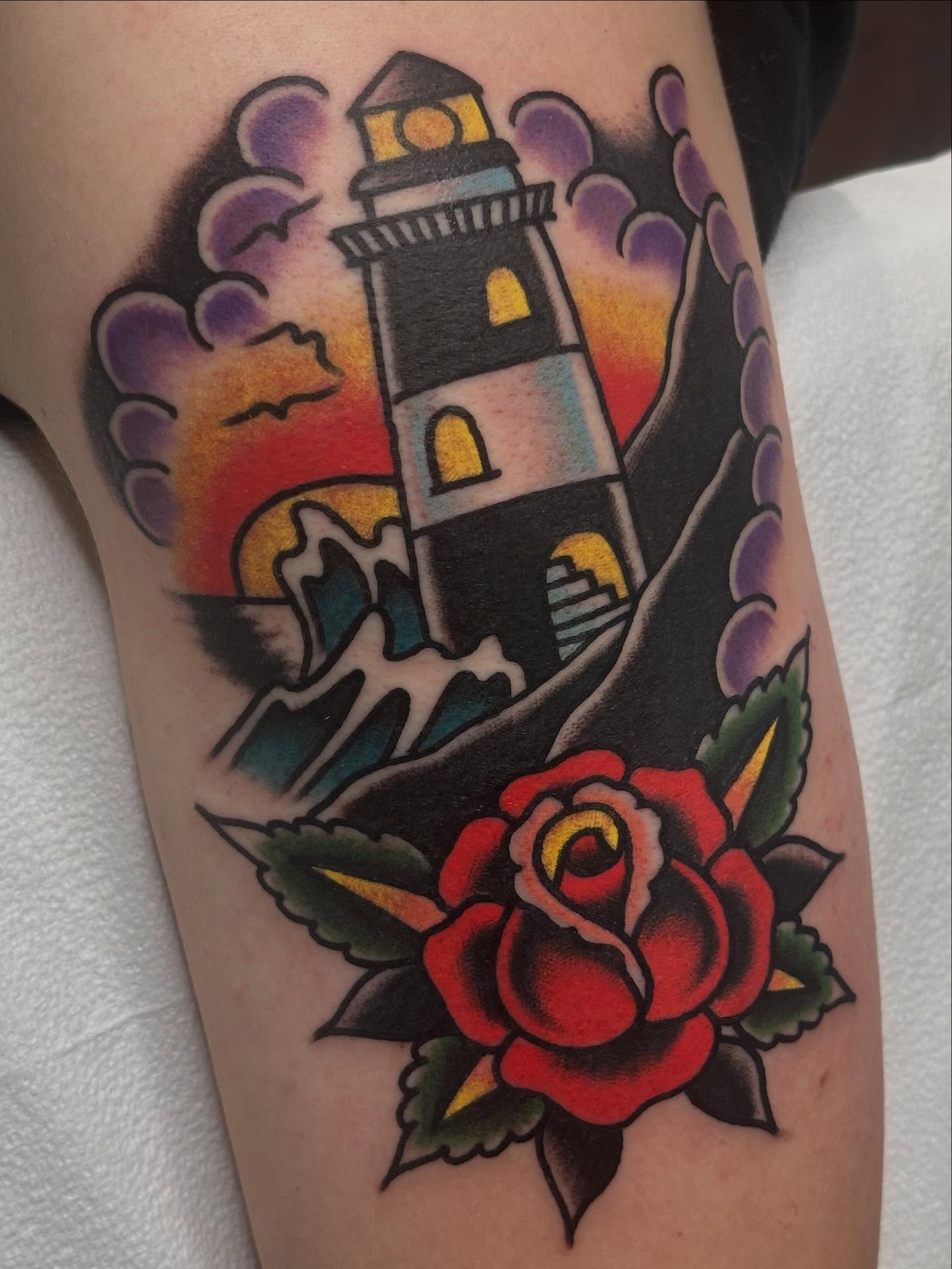 Lighthouse and rose American traditional tattoo on the forearm by Cody Woolard, Seymour, Tennessee