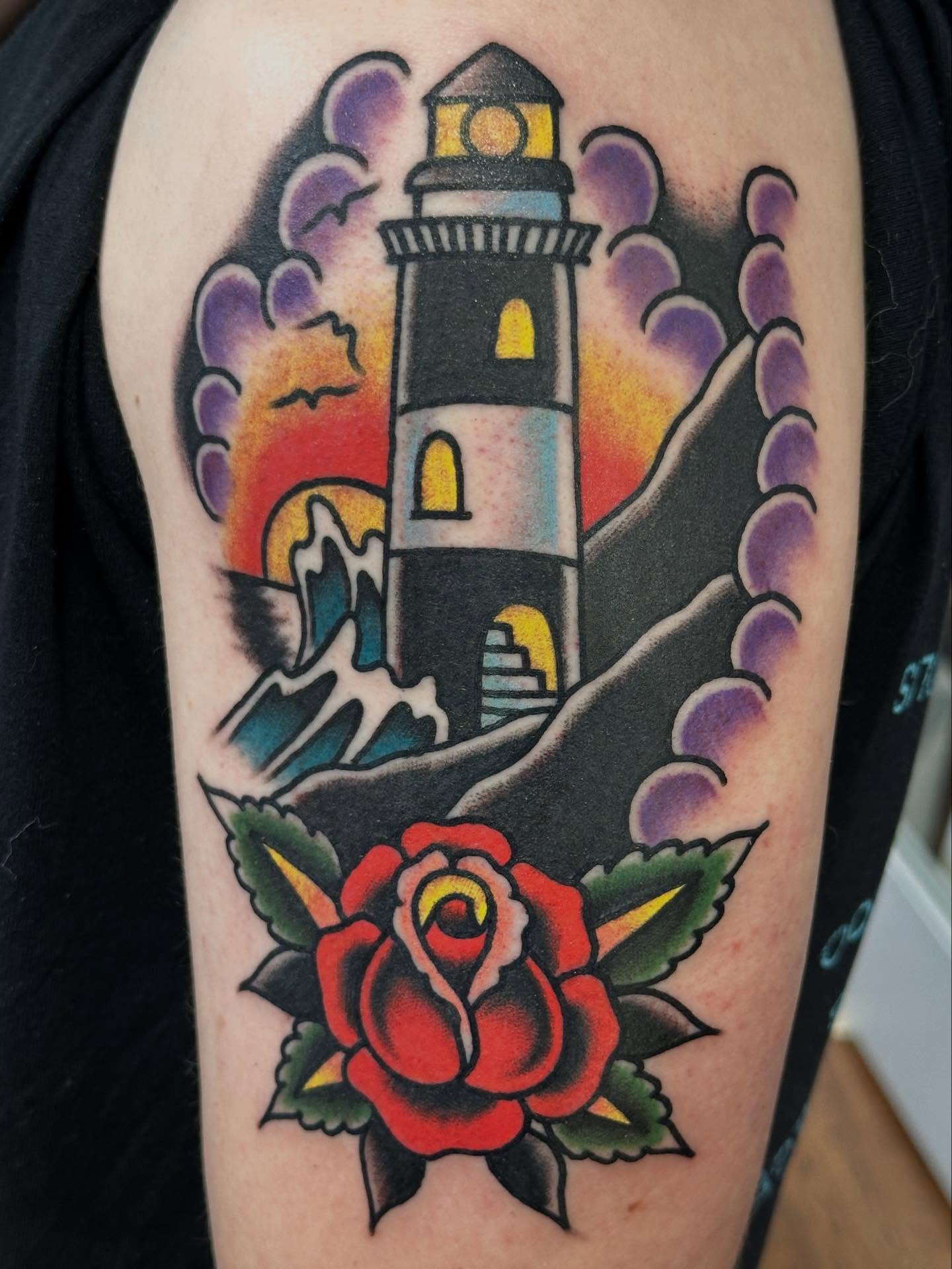 Lighthouse and rose American traditional tattoo on the forearm by Cody Woolard, Seymour, Tennessee