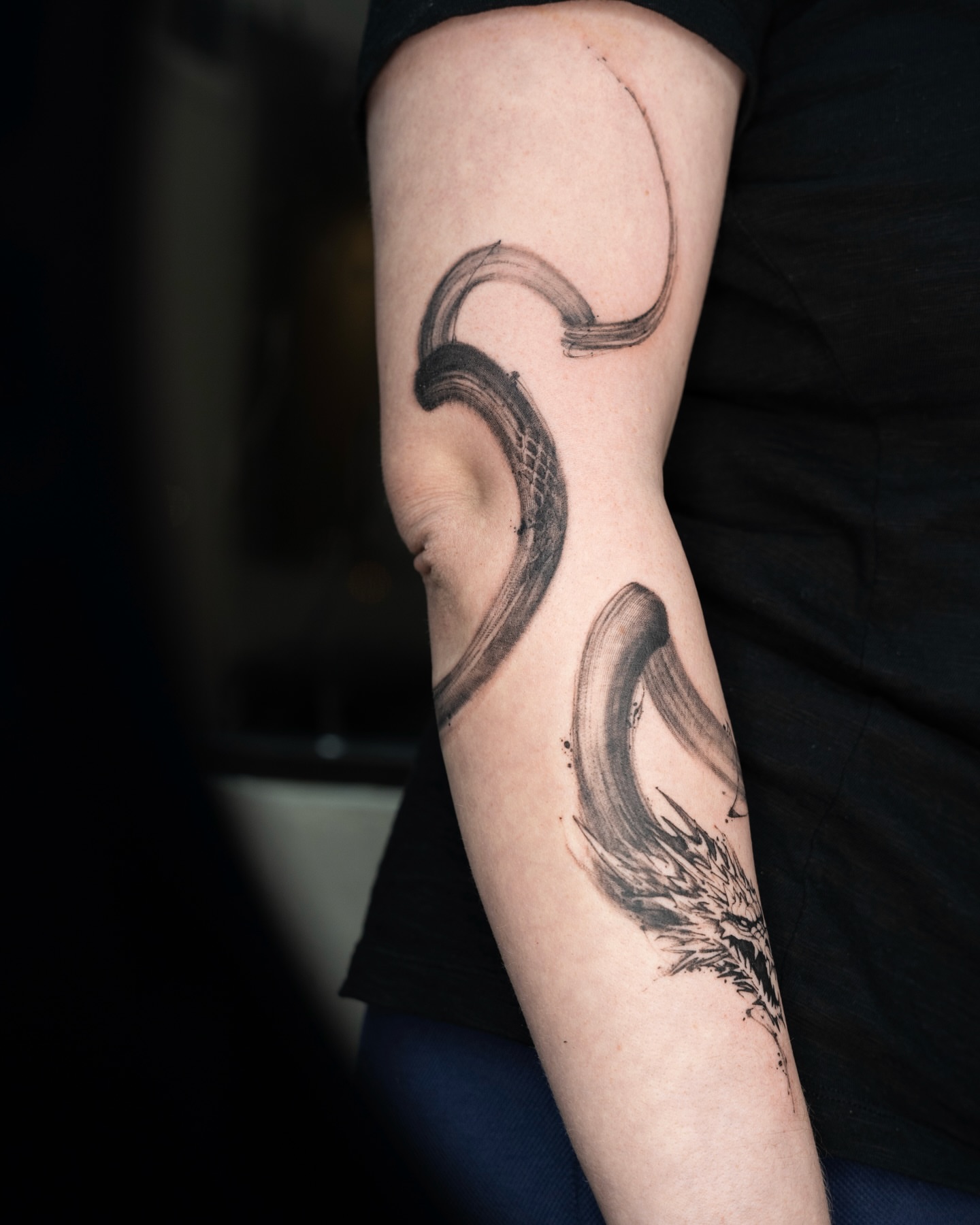 Wave black and grey tattoo on the forearm by Tri
