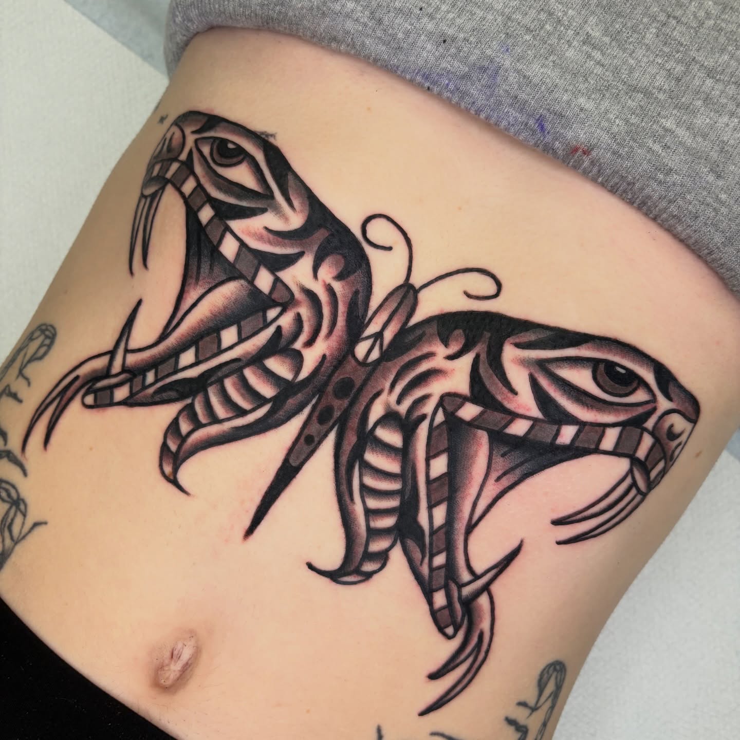 Snake black and grey tattoo on the thigh by rachael