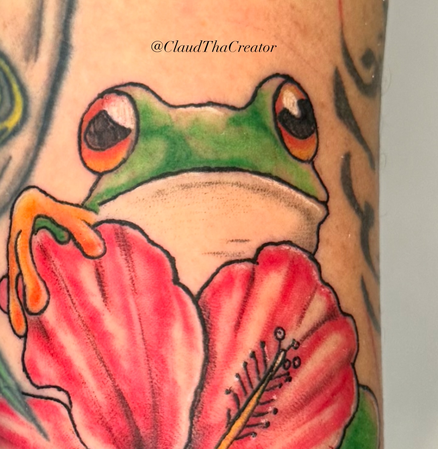 Frog and flower American traditional tattoo on the forearm by claud, Atlanta, Georgia