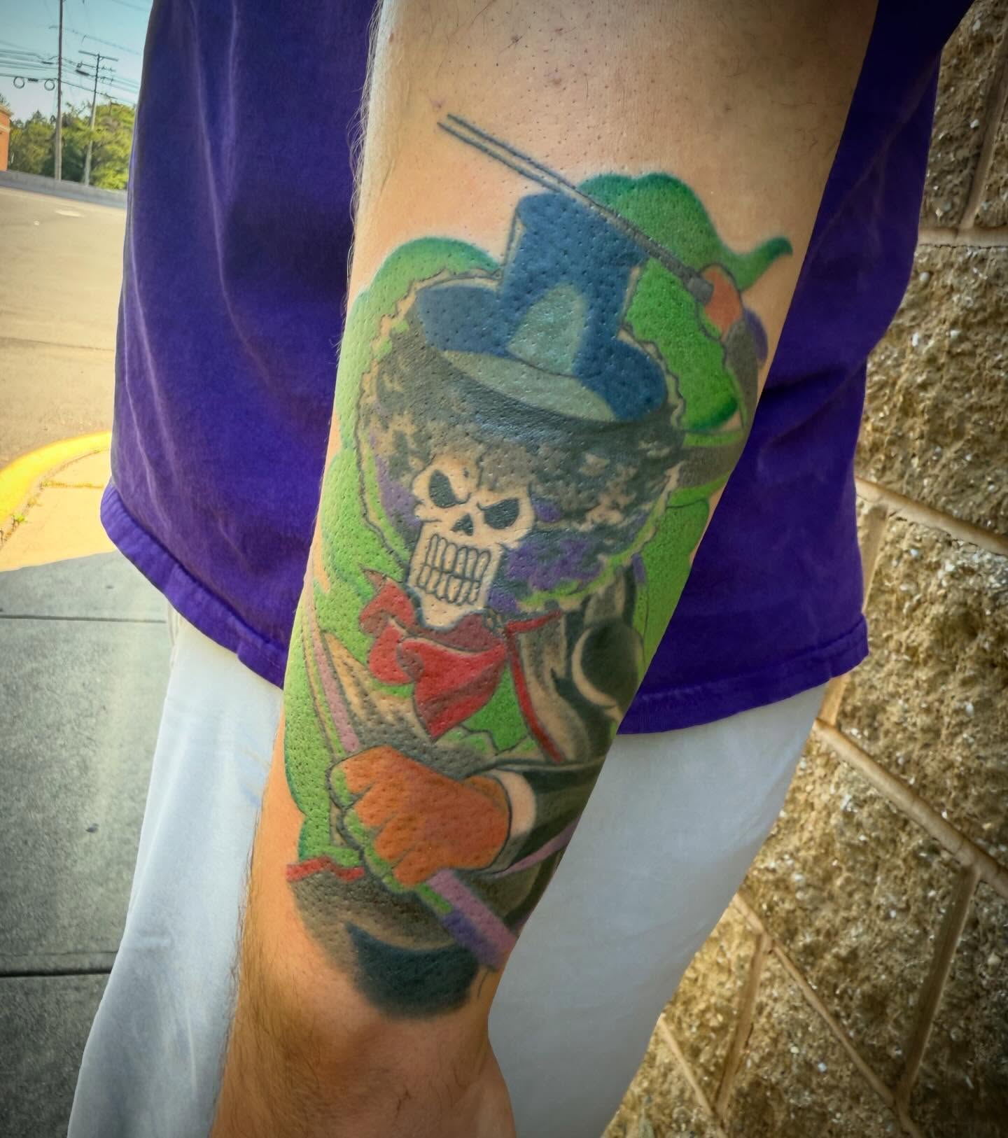 Joker skull American traditional tattoo on the forearm by Abby Hofman