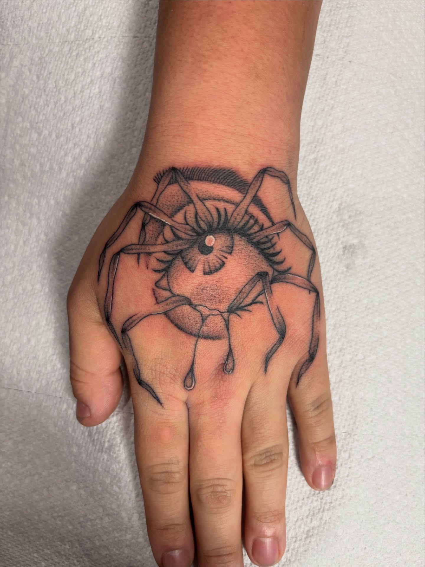 Spider black and grey tattoo on the hand by Miklo Montoya