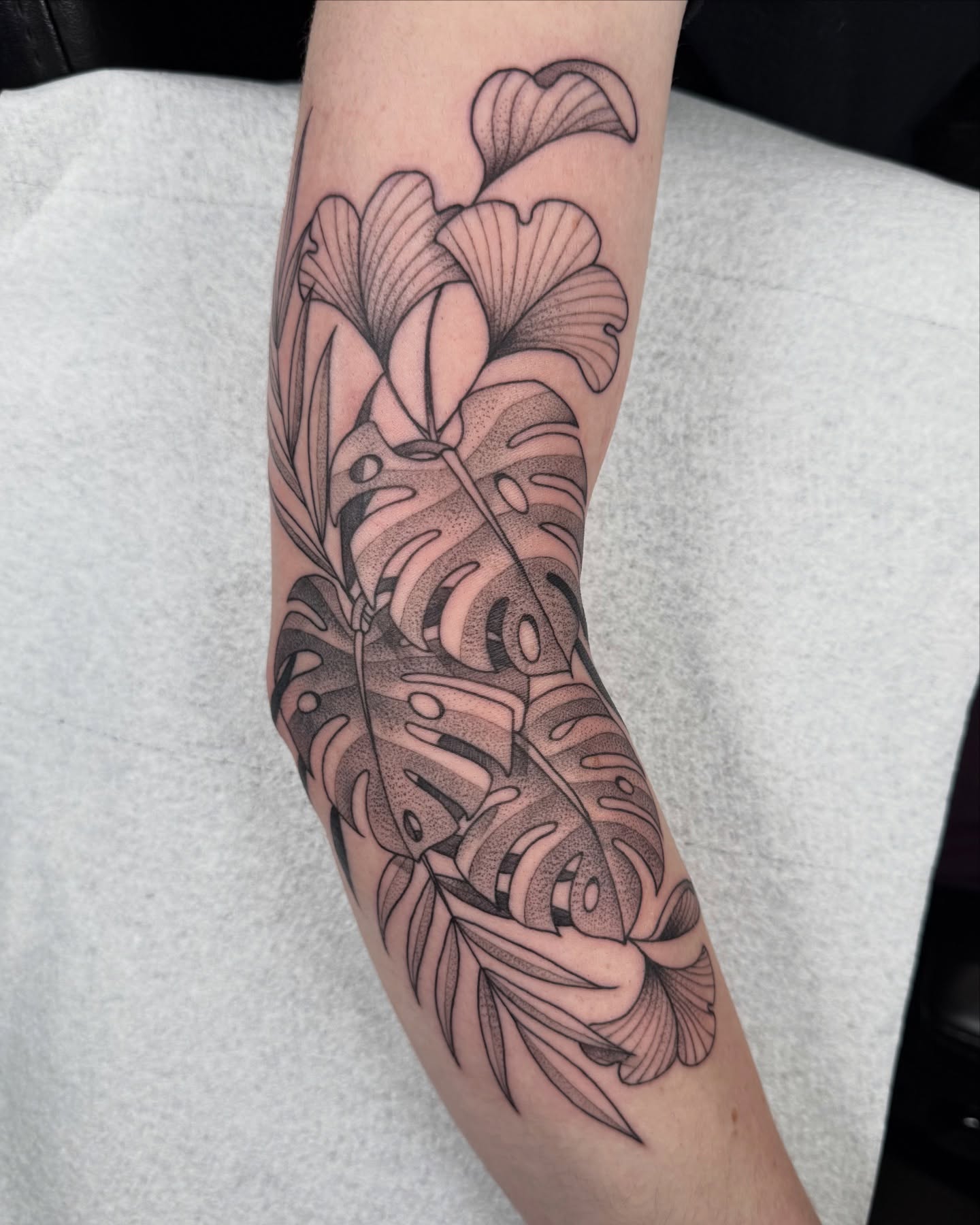 Monstera leaves dotwork tattoo on the forearm by Miles Romero Smith
