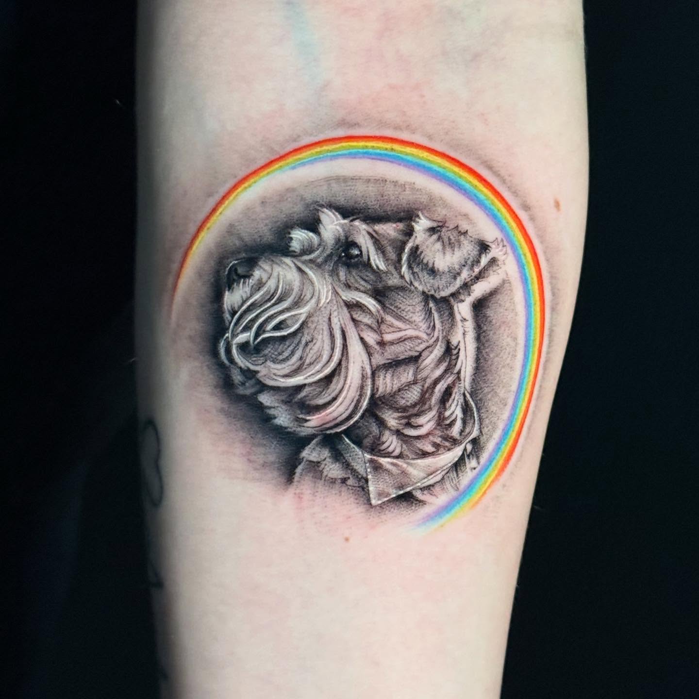 Dog with rainbow realism tattoo on the forearm by HAiZiE