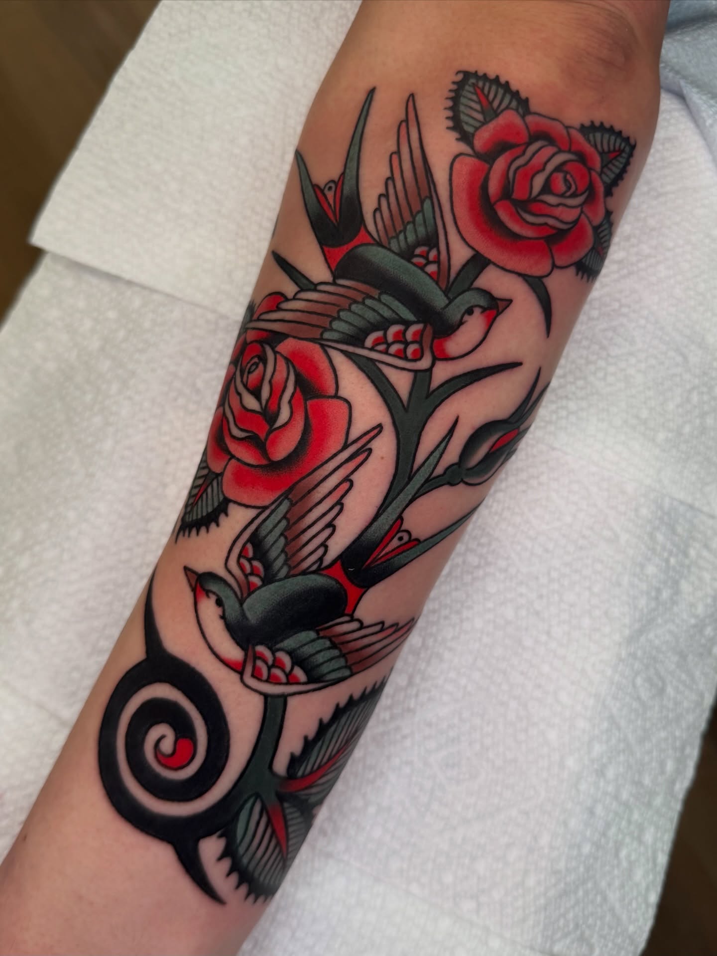 Birds and roses American traditional tattoo on the forearm by kate