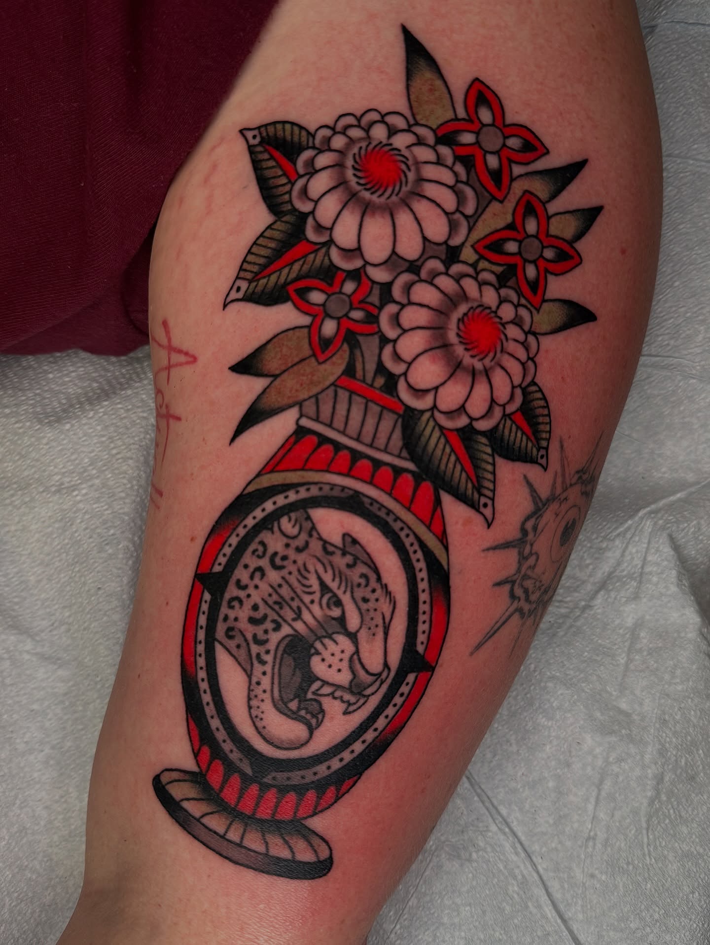 Jaguar and flowers American traditional tattoo on the thigh by kate