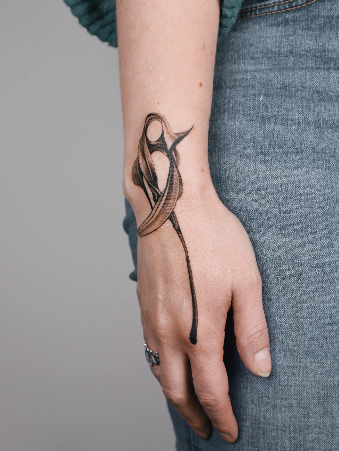 Abstract design black and grey tattoo on the hand by River, New York, New York