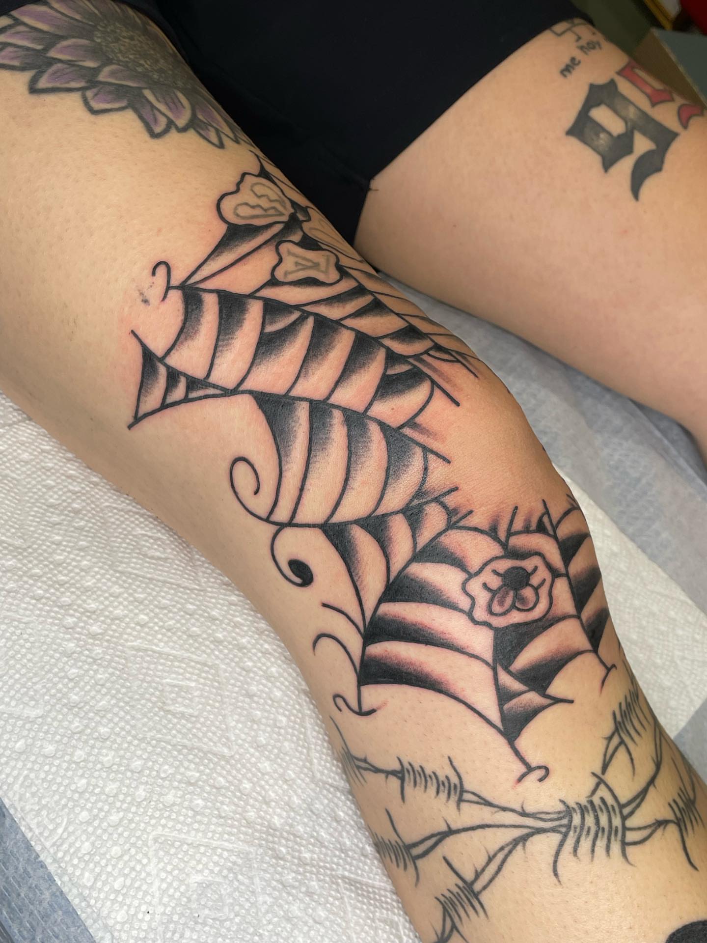Snake and peony American traditional tattoo on the forearm by Nicholas M. Passeri