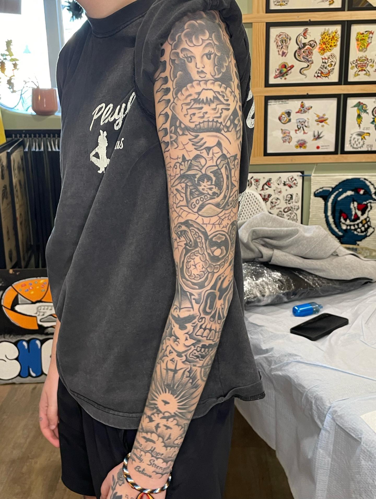 Woman with snake American traditional tattoo on the forearm by Nicholas M. Passeri