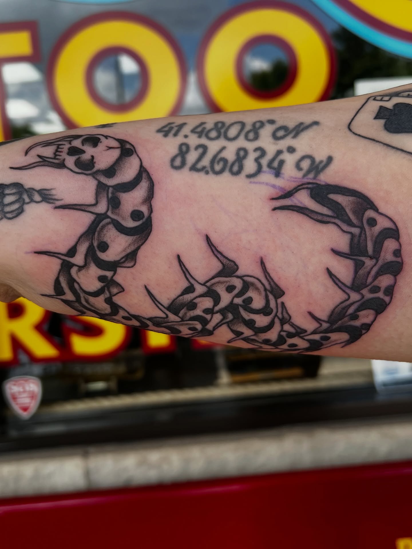 Snake and compass American traditional tattoo on the forearm by Josh Kronauer