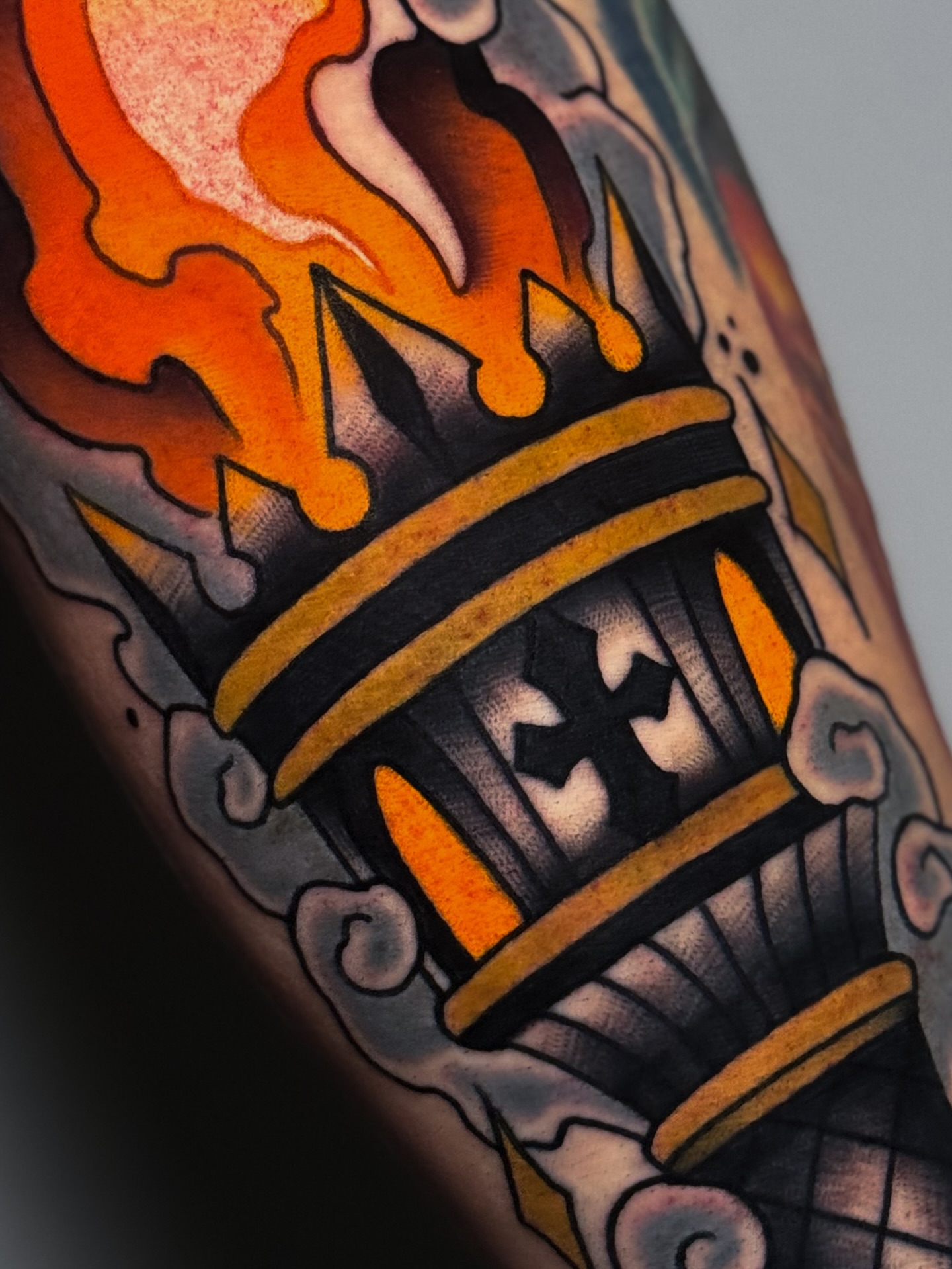 Flame crown American traditional tattoo on the forearm by Cory Cartwright