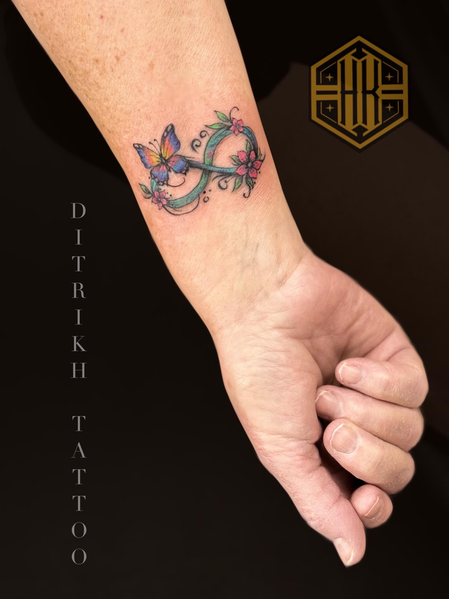 Butterfly and floral new school tattoo on the forearm by KET, Calgary, Alberta