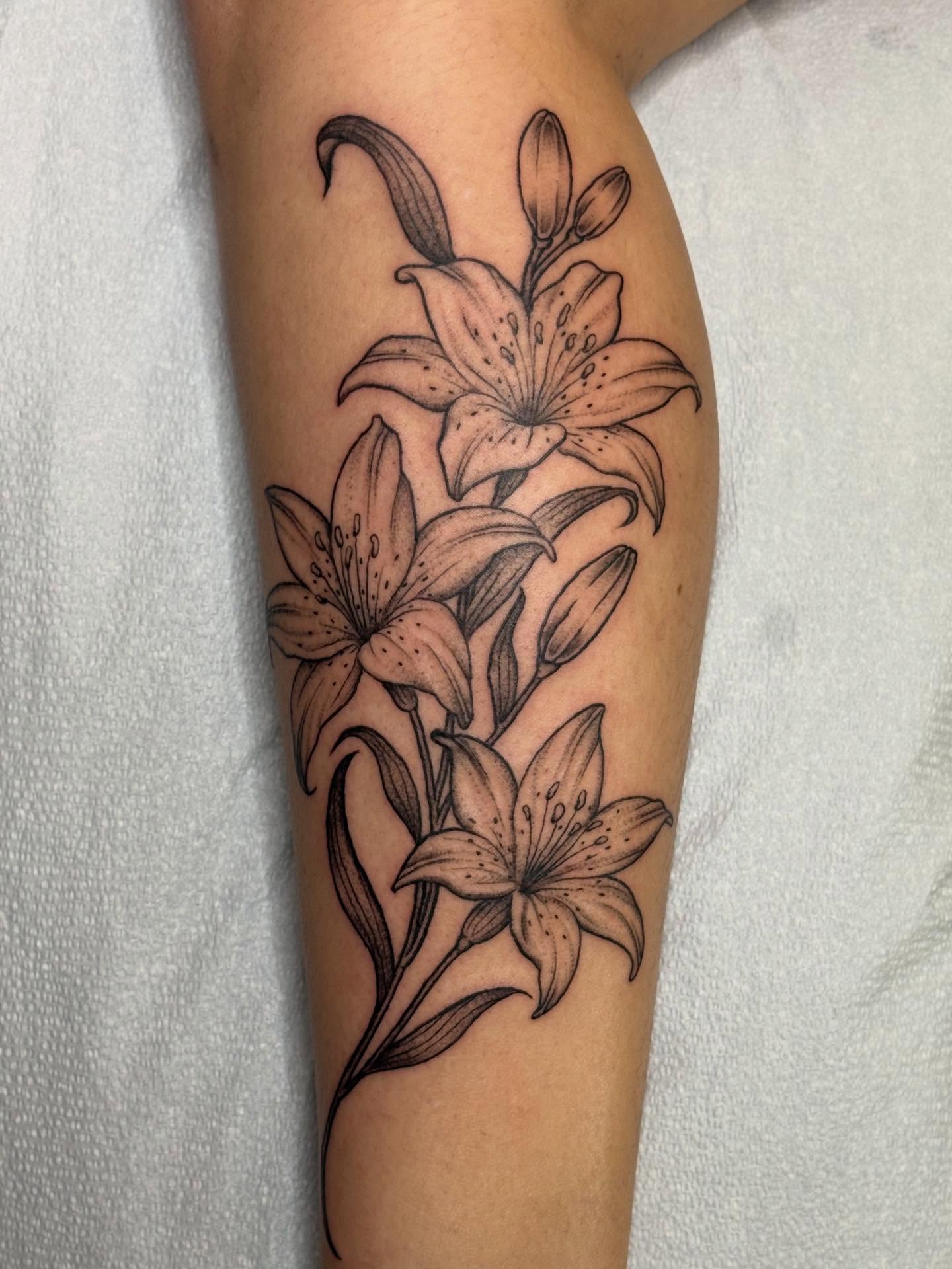 Lilies black and grey tattoo on the forearm by ☻︎ Cyd Precious ☹︎