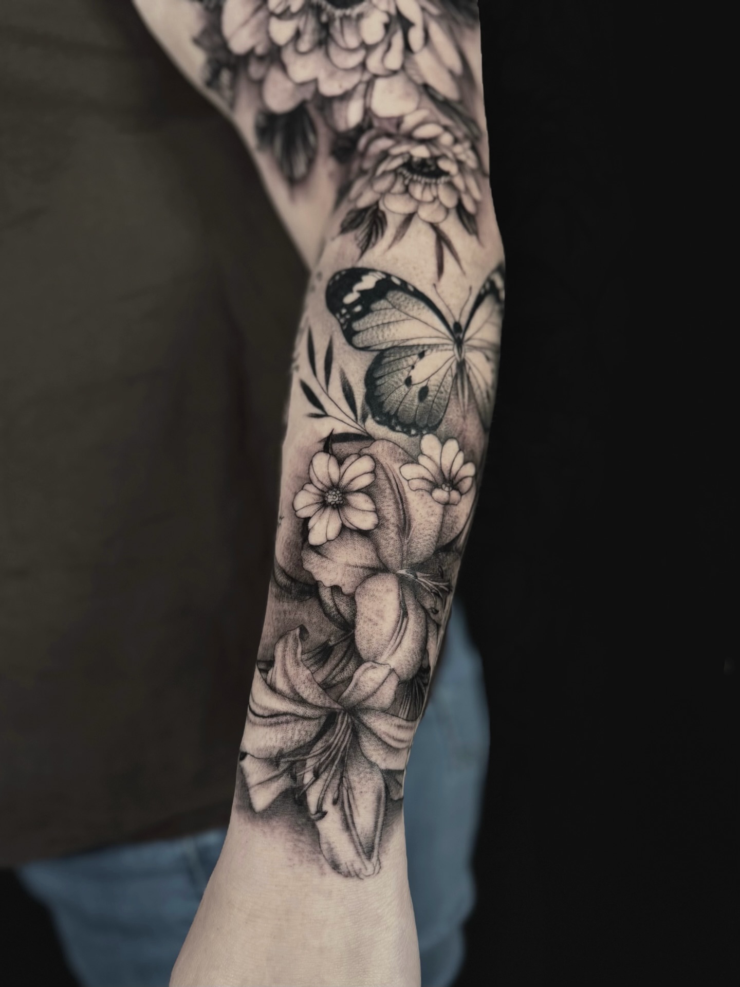 Flowers and butterfly realism tattoo on the forearm by Abi