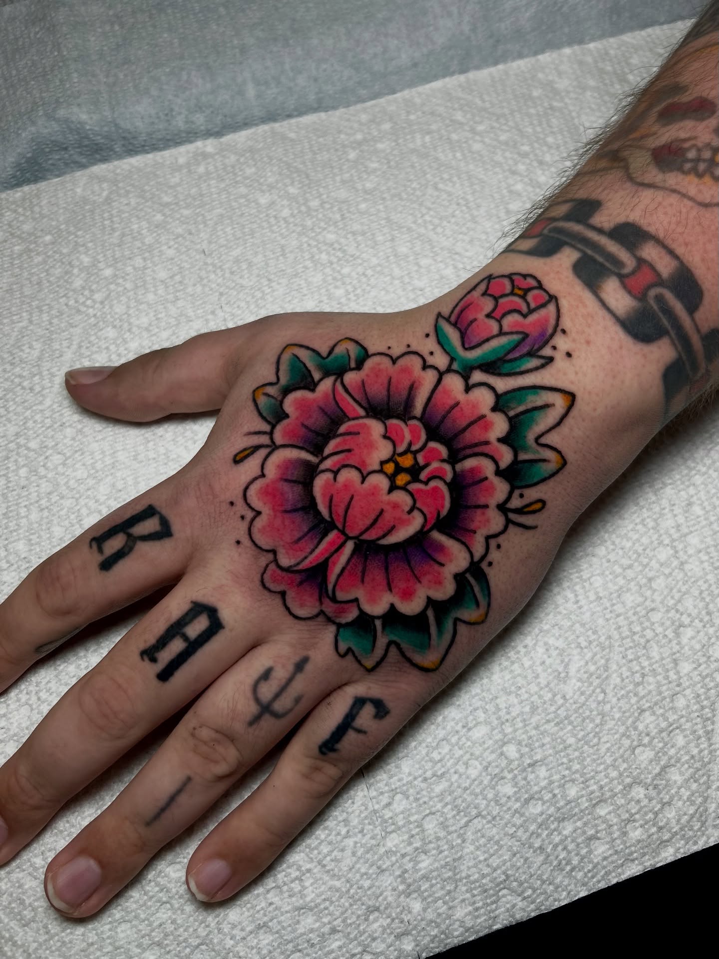 Peony American traditional tattoo on the hand by Lily May