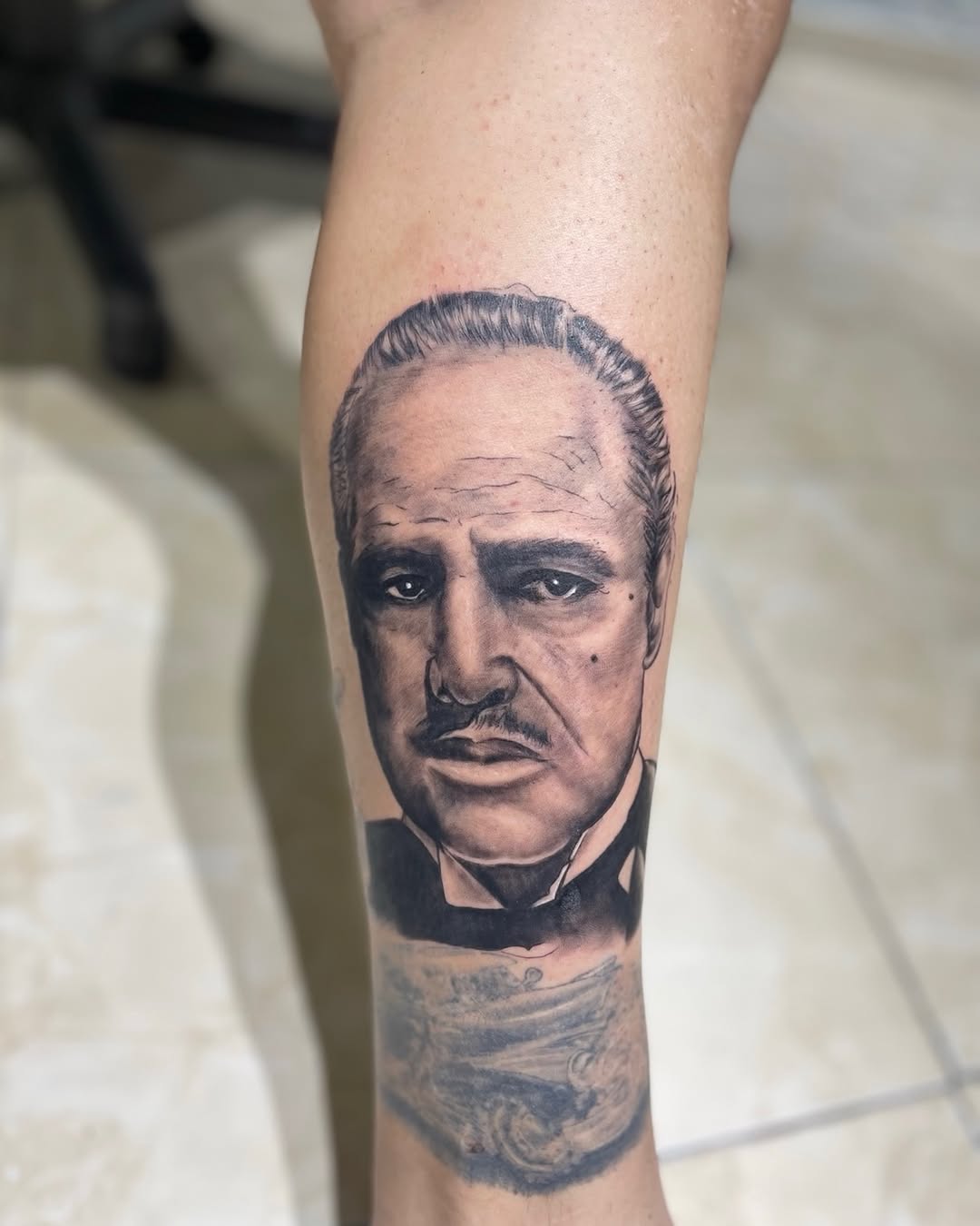 Man and car realism tattoo on the forearm by Mauricio gois