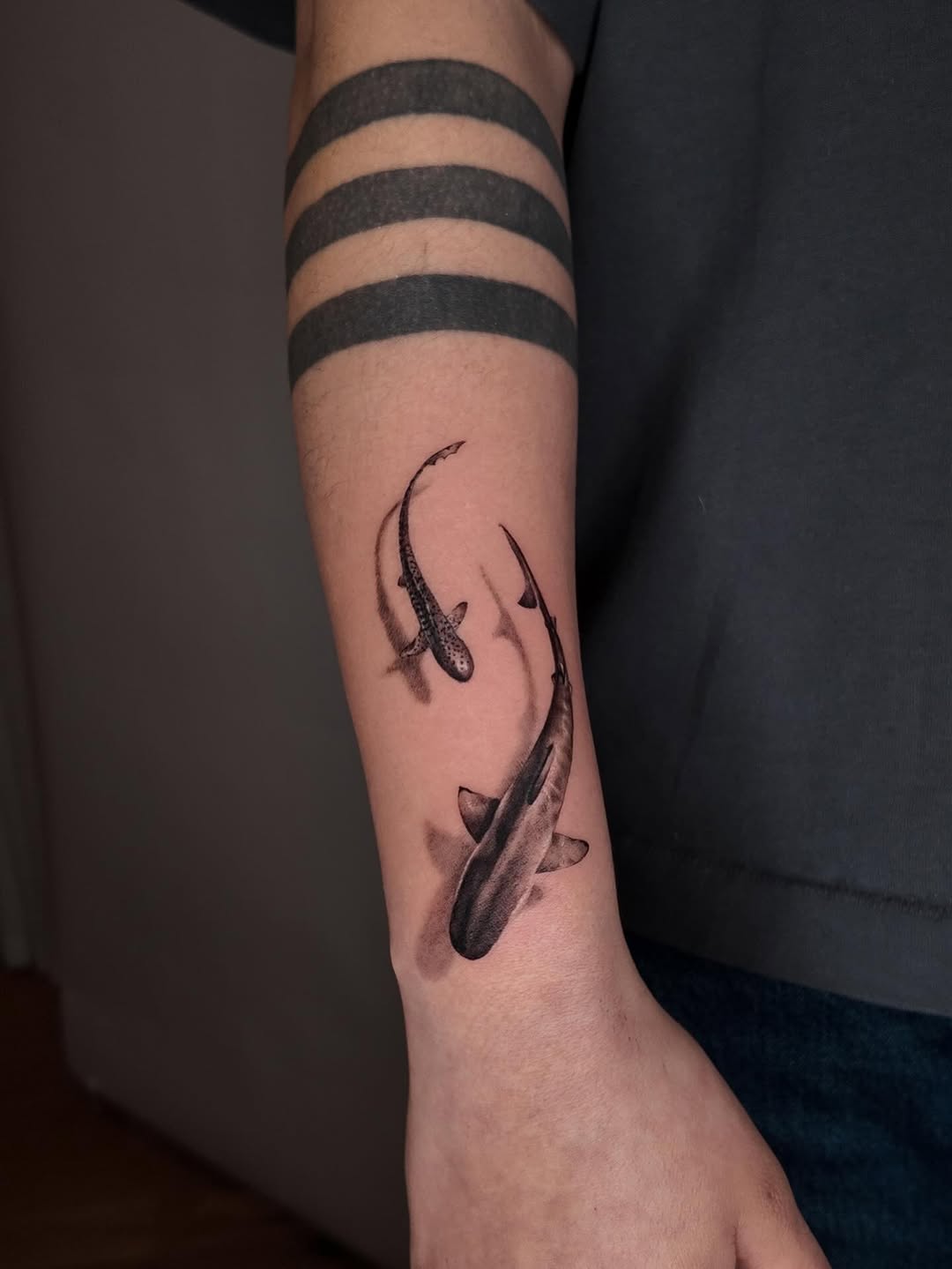 Two sharks fine line tattoo on the forearm by Gabriel