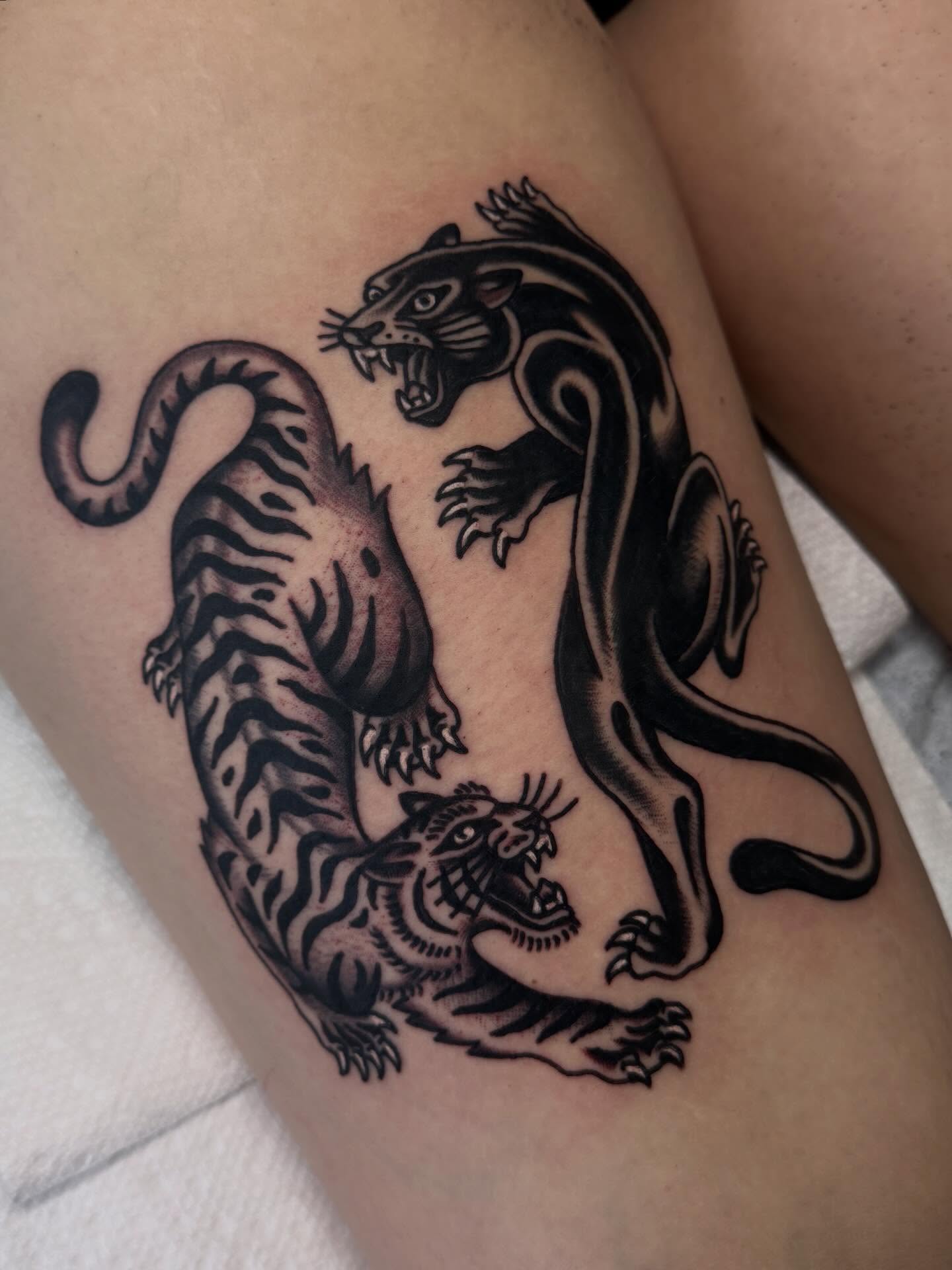 Tigers black and grey tattoo on the thigh by Ryan Engels