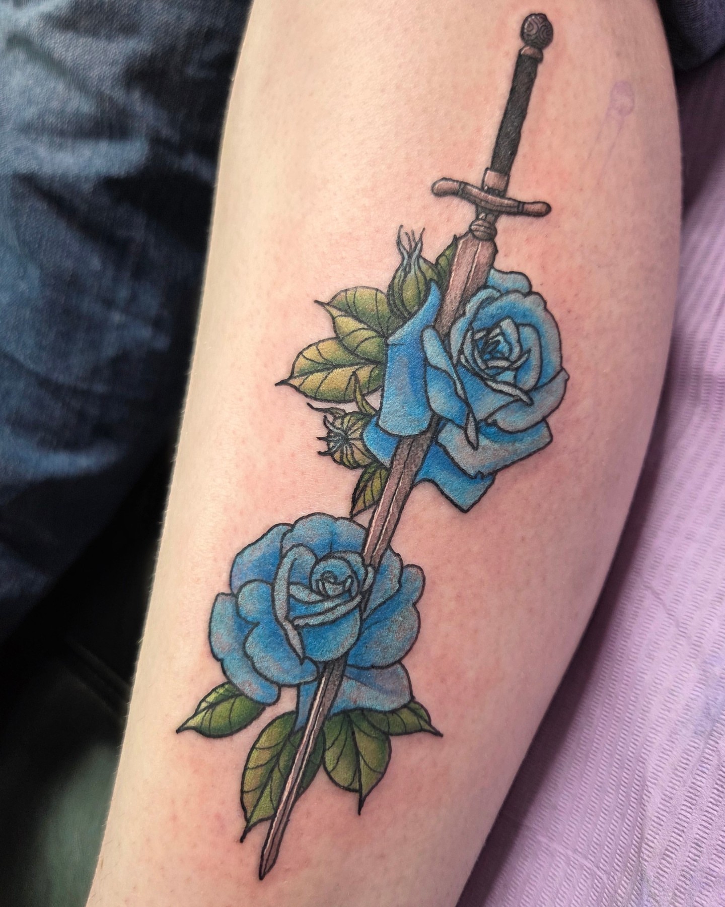 Sword and roses American traditional tattoo on the thigh by Trinity Renee