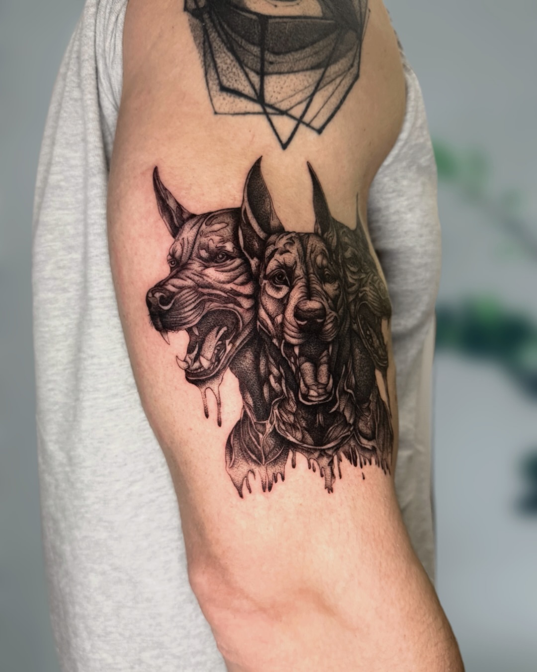 Dogs realism tattoo on the forearm by Ingrid Rojas