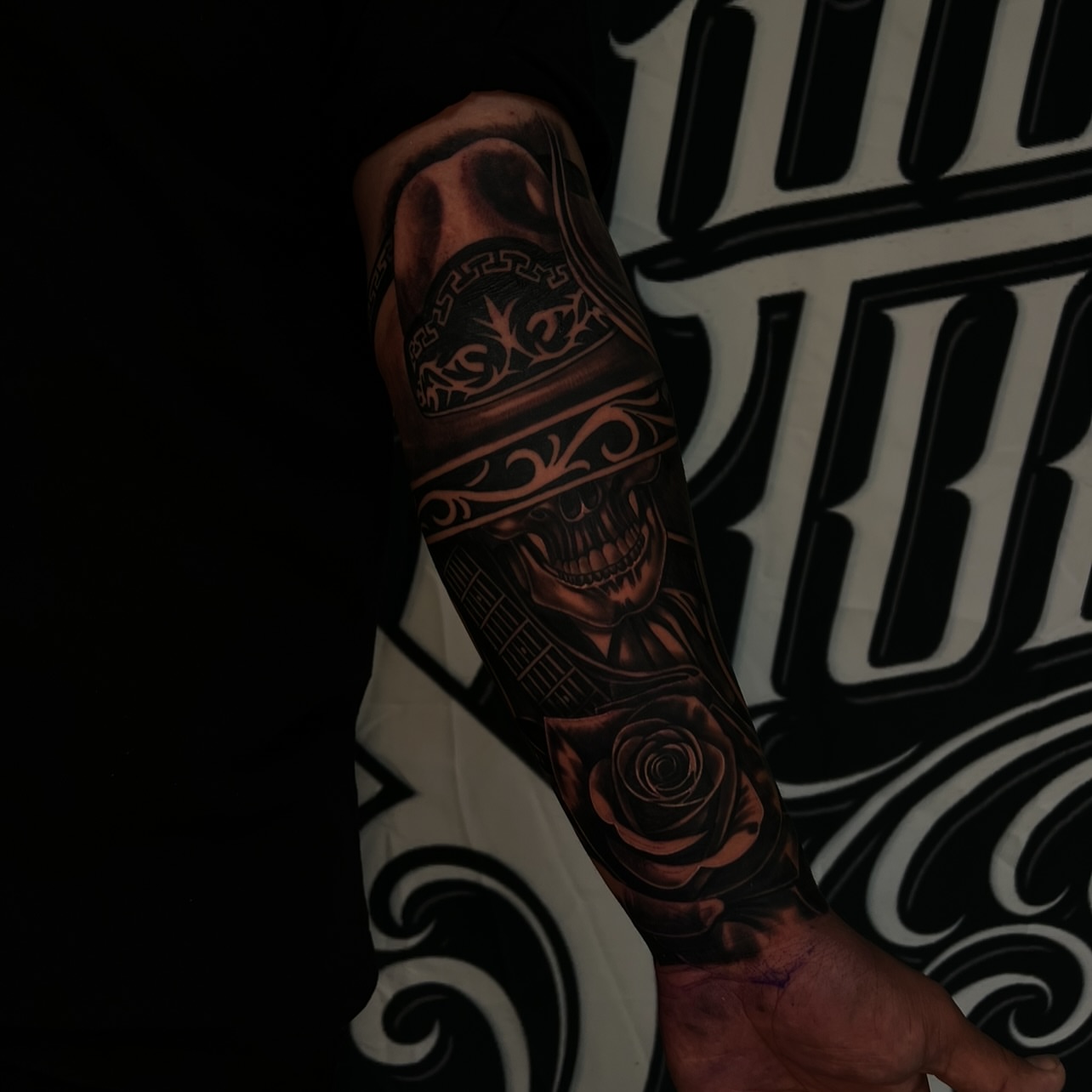 Skull and roses realism tattoo on the forearm by Daniel Michael Perez