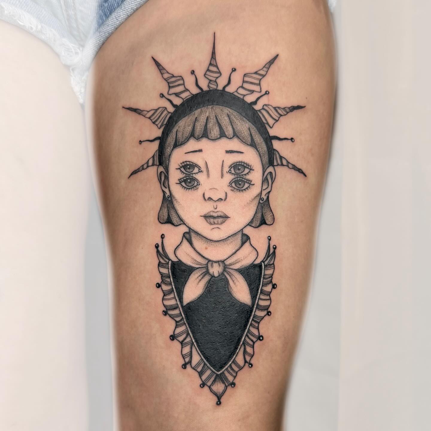 Doll head geometric tattoo on the thigh by Nika