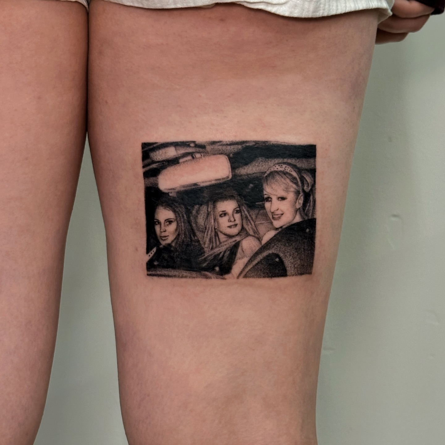 Three women in car realism tattoo on the thigh by kale