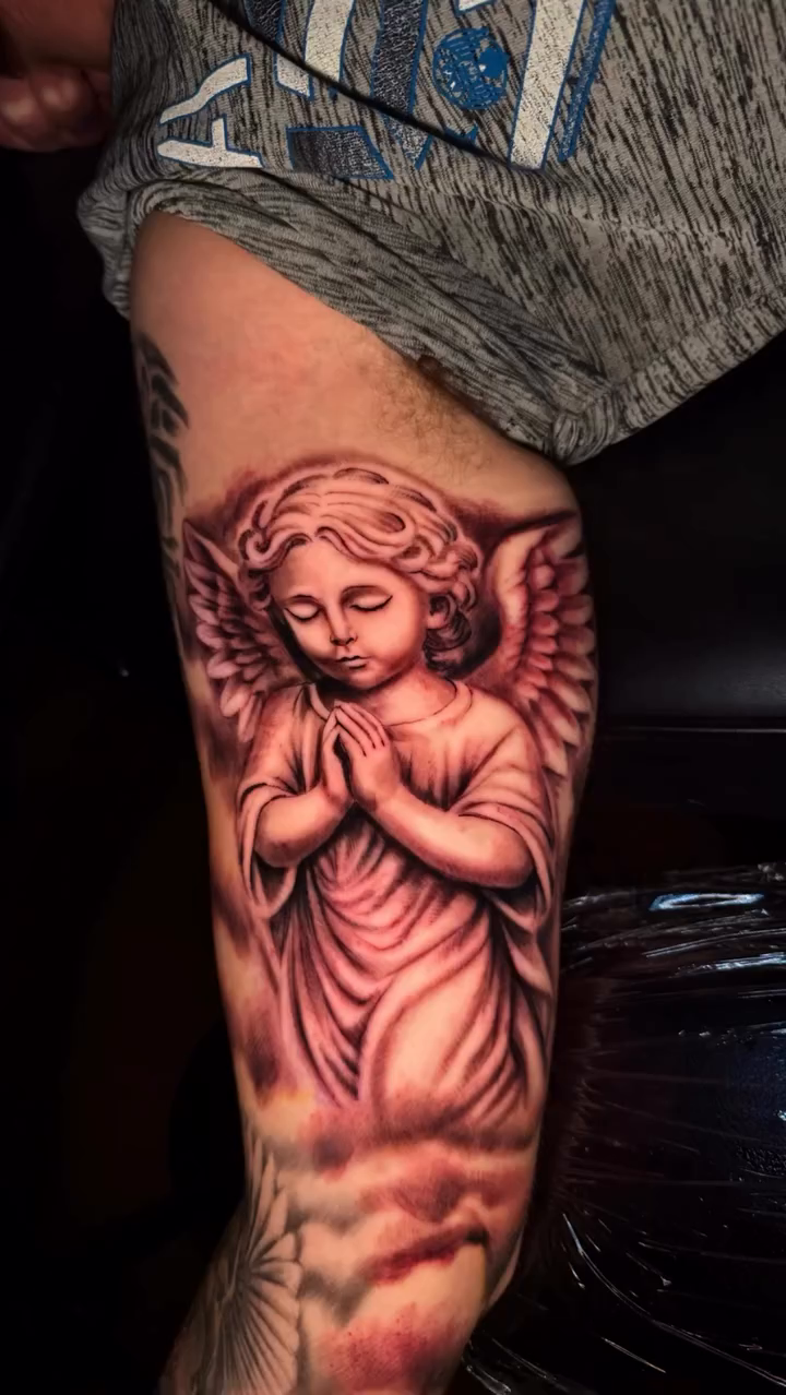 Angel with clouds realism tattoo by Jacob Martin, Toledo, Ohio