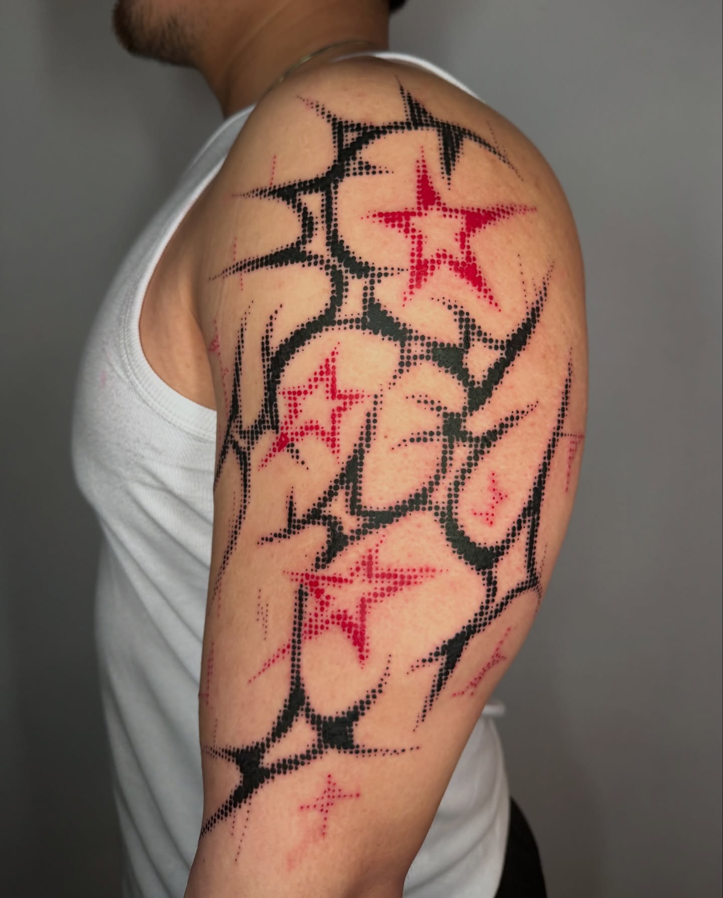 Stars dotwork tattoo on the shoulder by Sophia Tattoo