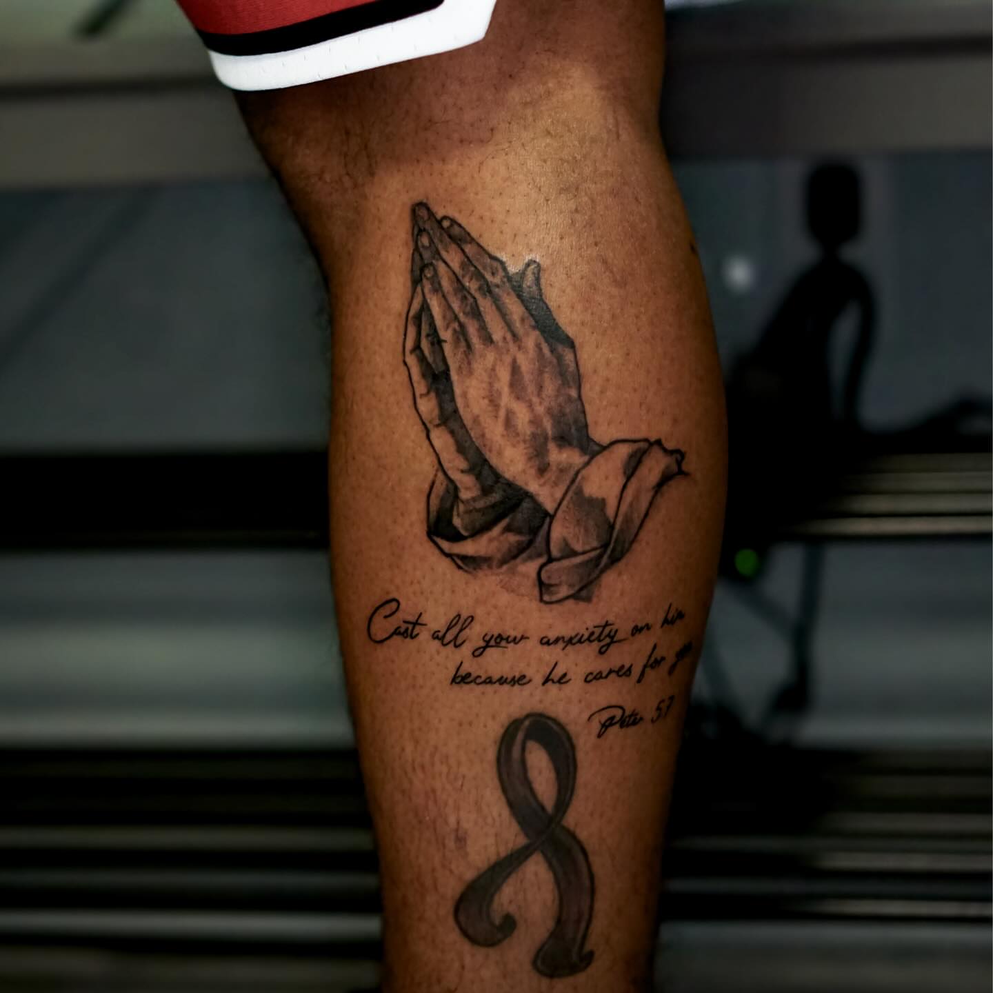 Praying hands black and grey tattoo on the calf by Nicholas Capellan, Winter Park, Florida