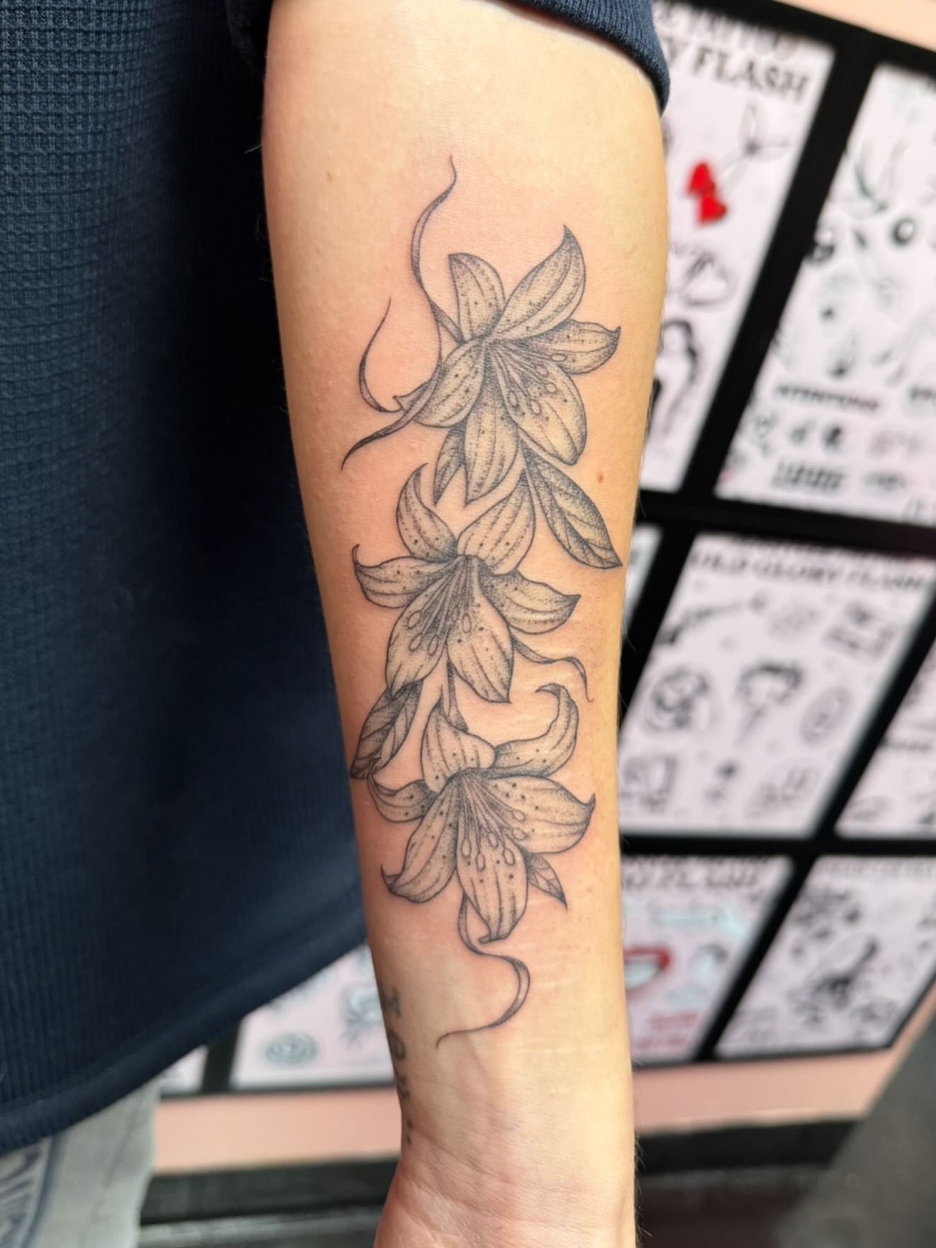 Lily black and grey tattoo on the forearm by Jennylee Aerts, Asbury Park, New Jersey