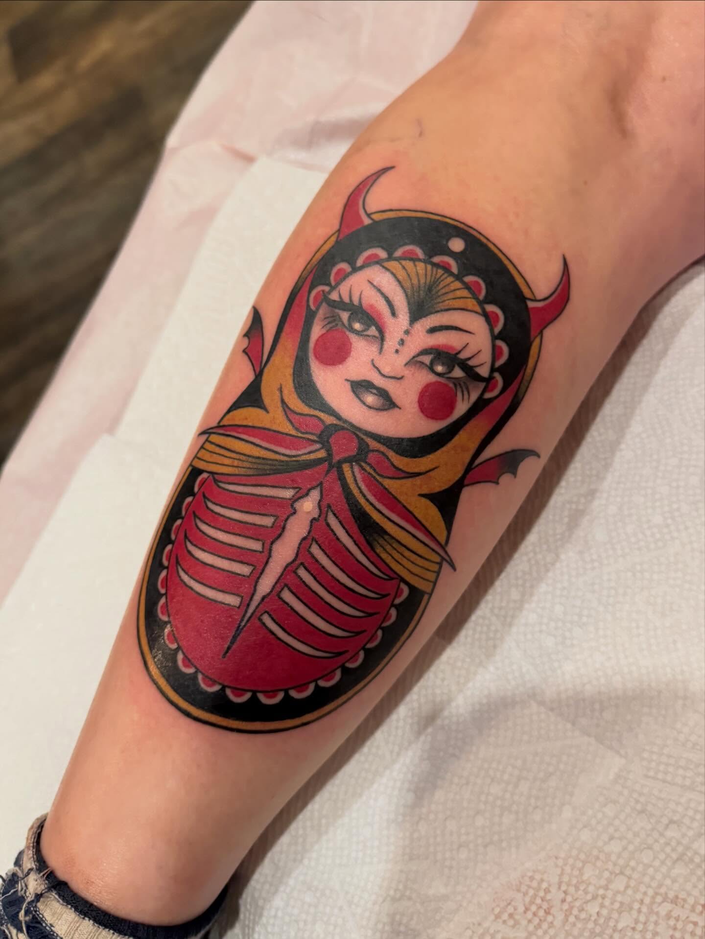 Demon doll American traditional tattoo on the forearm by Paul Giovis